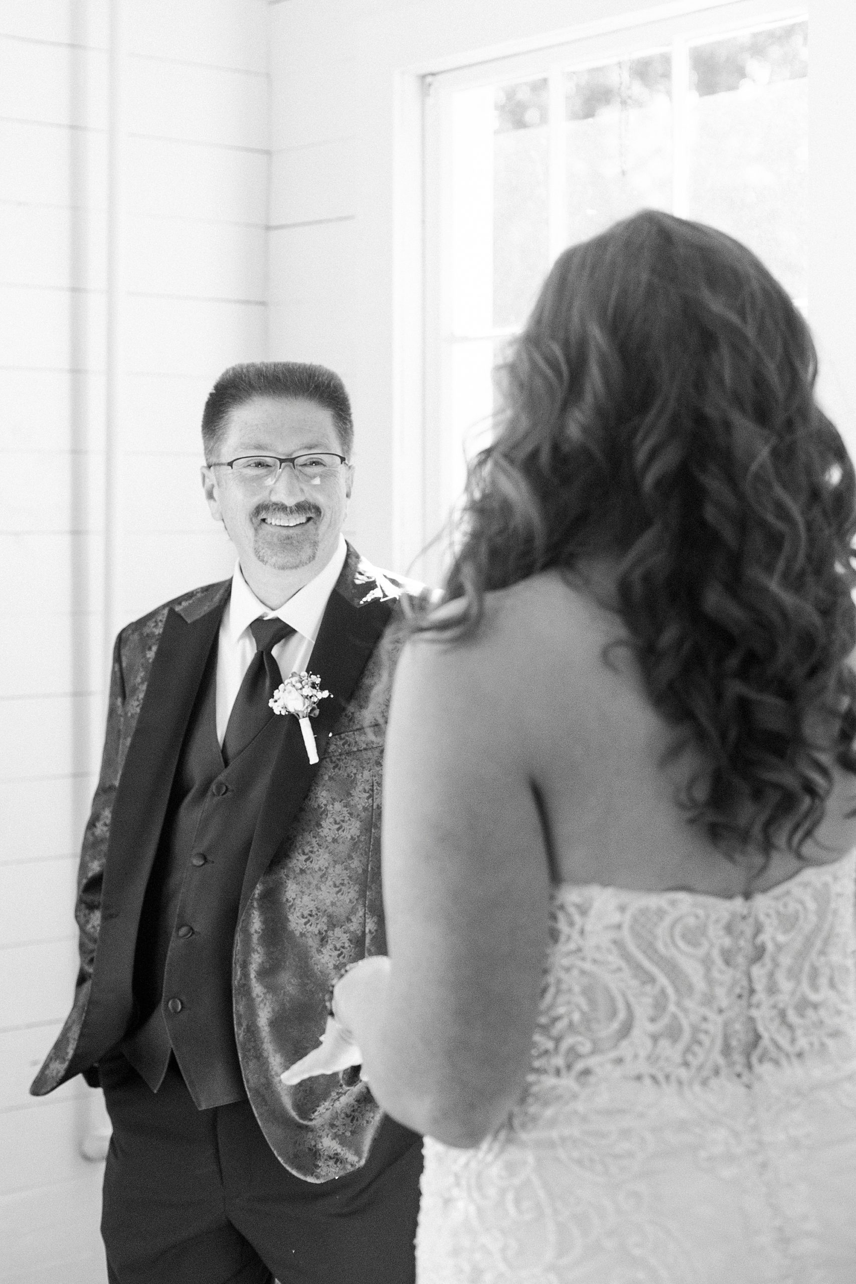dad smiles at bride during first look