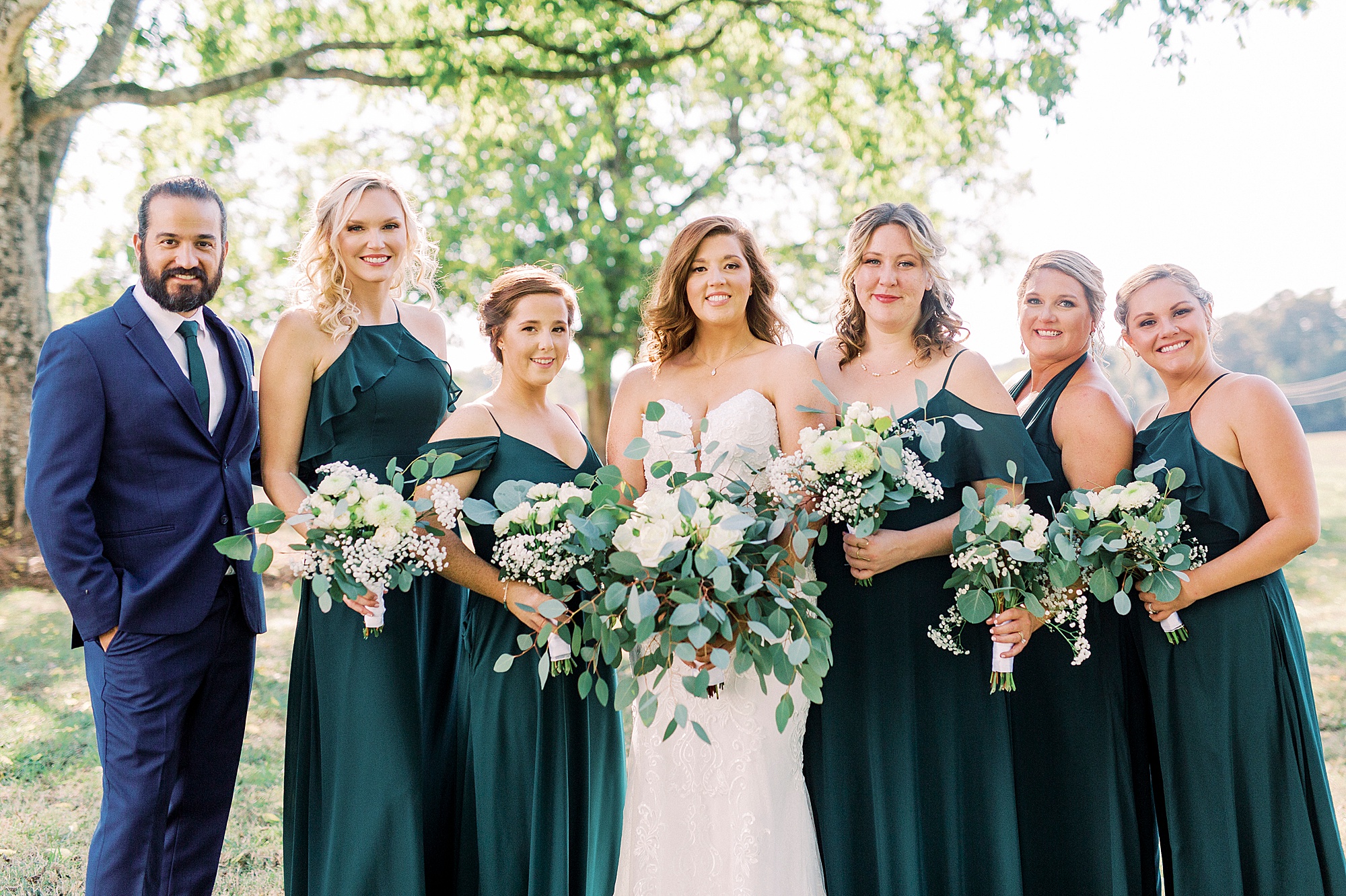 bride smiles with bridesmaids before The Dairy Barn wedding