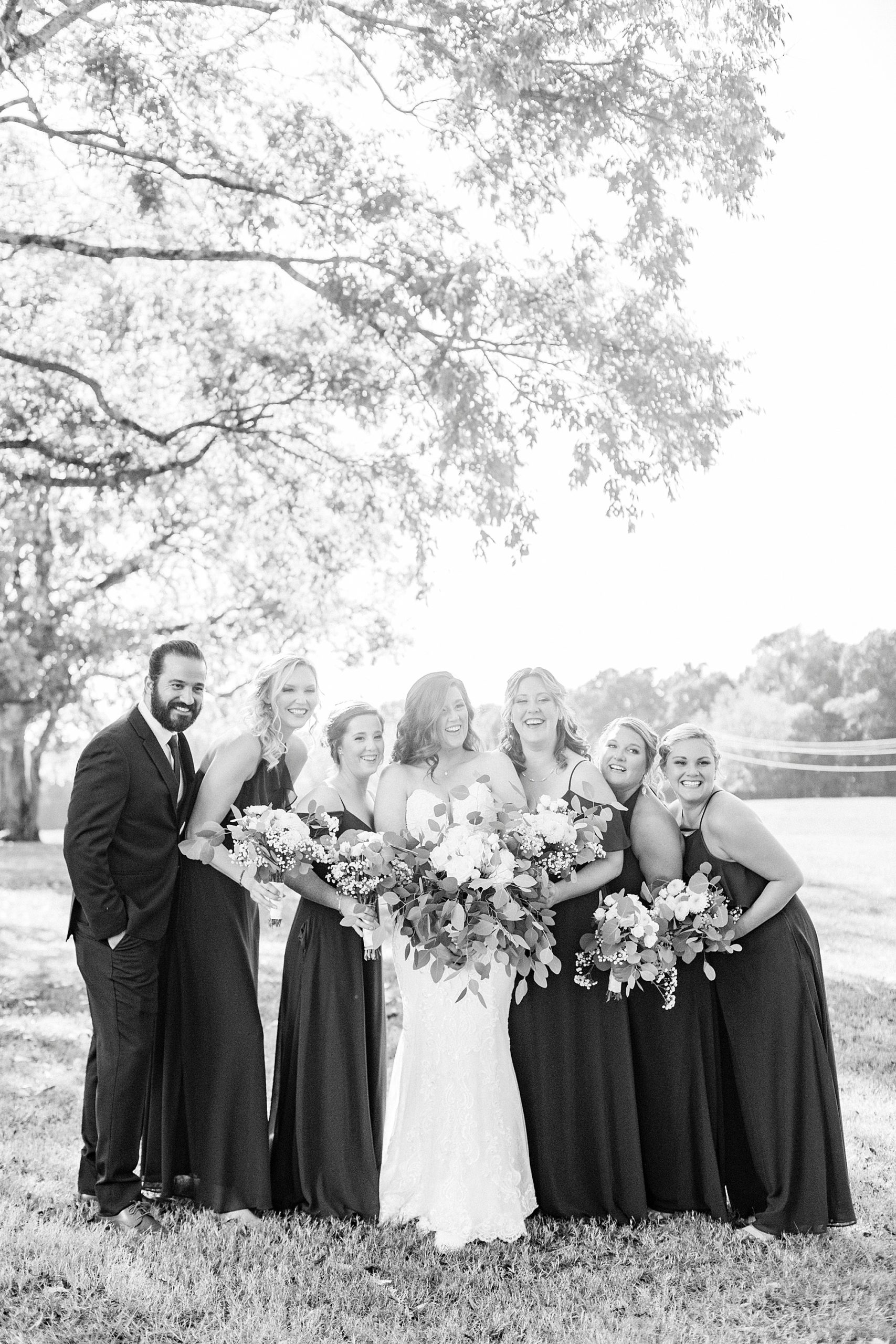 bride laughs with bridesmaids during prep for The Dairy Barn wedding