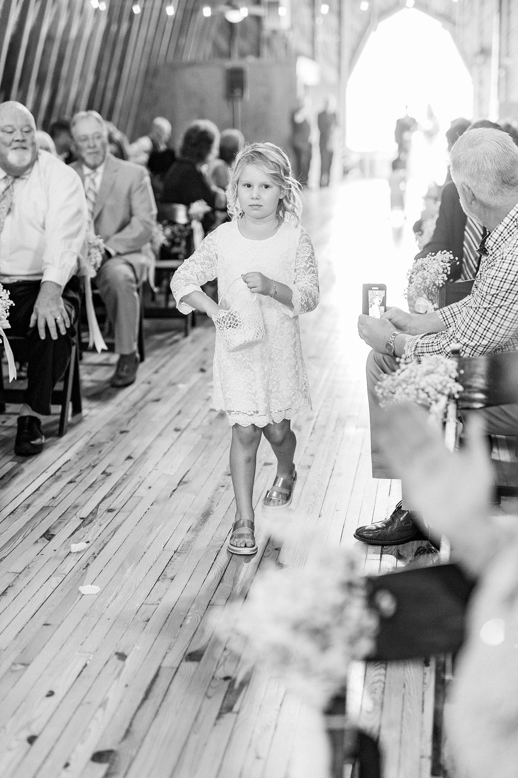 flower girl throws petals during wedding ceremony