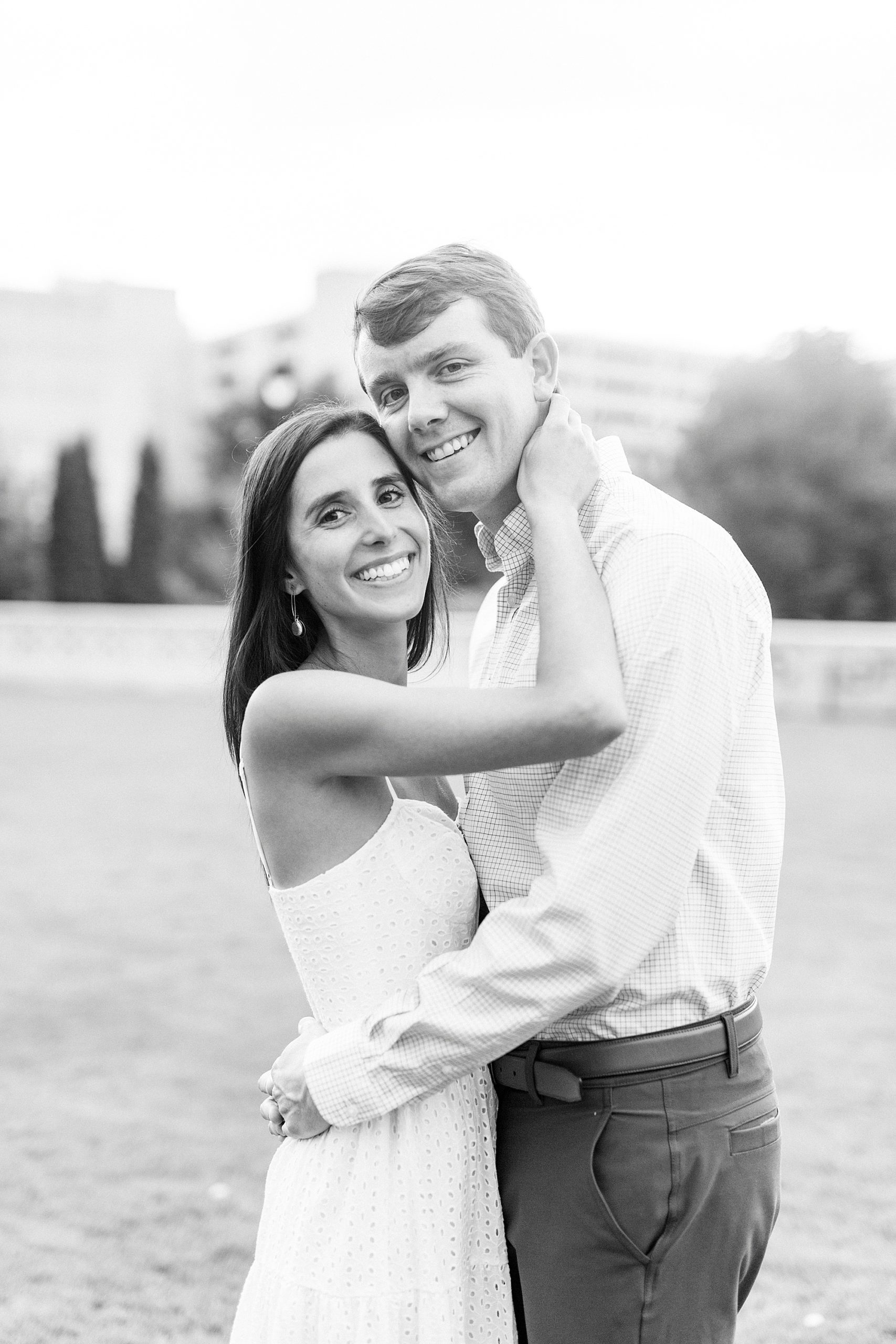 bride and groom hug in Midtown Park during engagement photos