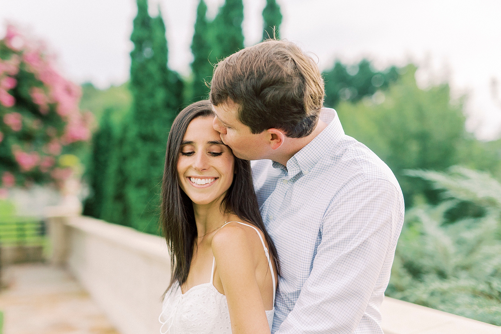 groom kisses bride's forehead during Charlotte NC engagement session