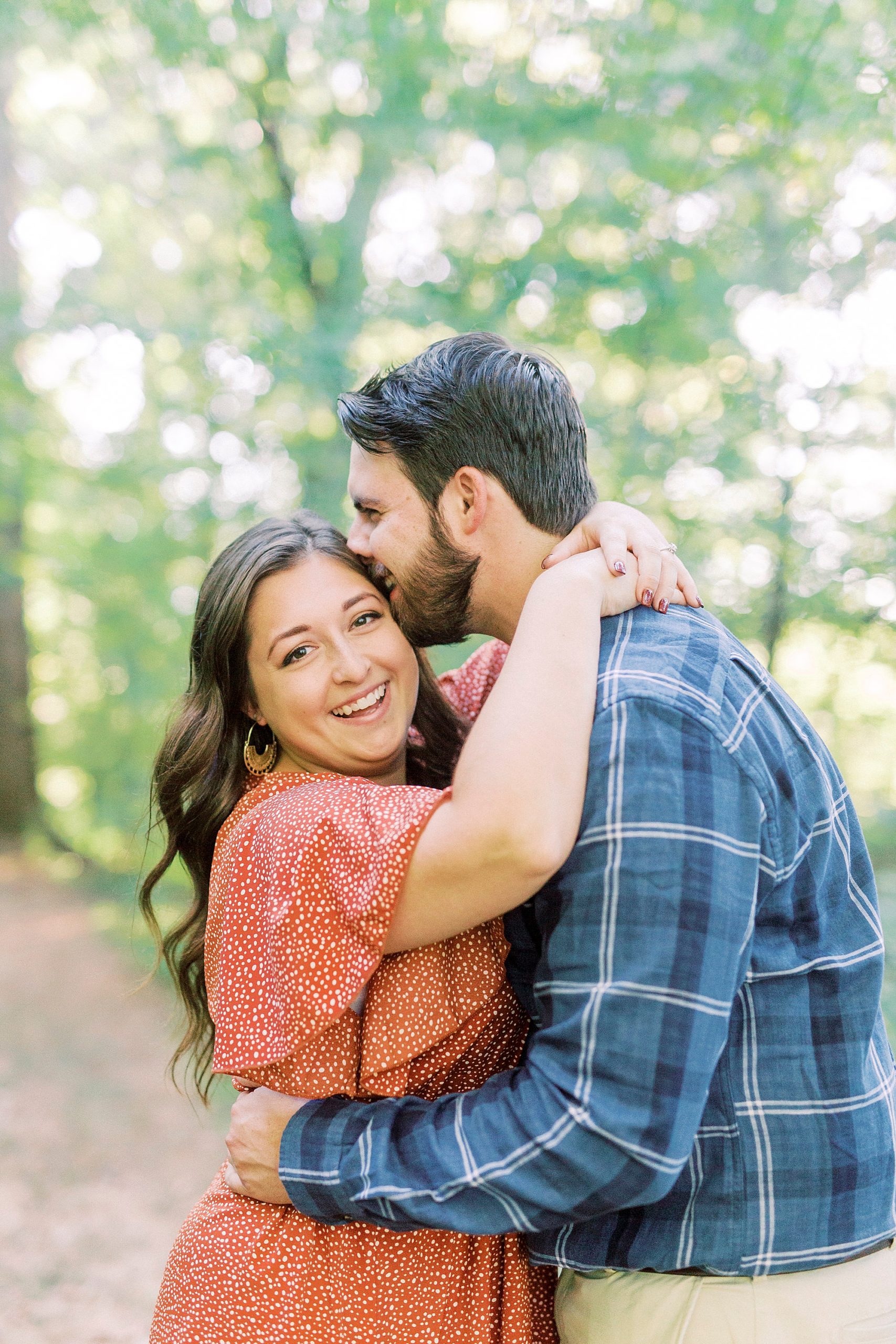 groom kisses bride's forehead during Sloan Park engagement session