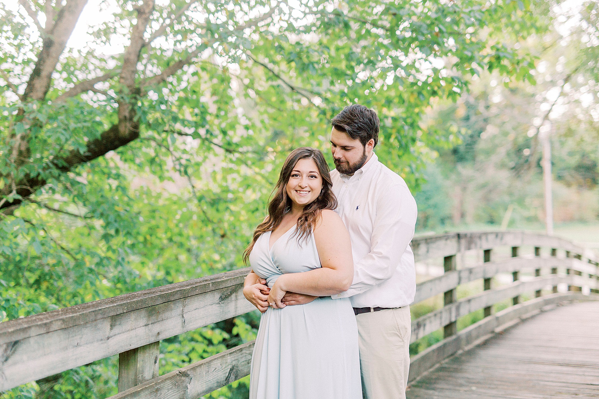 groom hugs bride from behind during Salisbury NC engagement session
