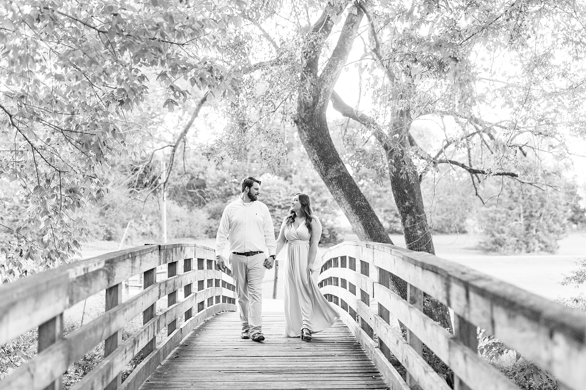 bride and groom walk over wooden bridge in Sloan Park