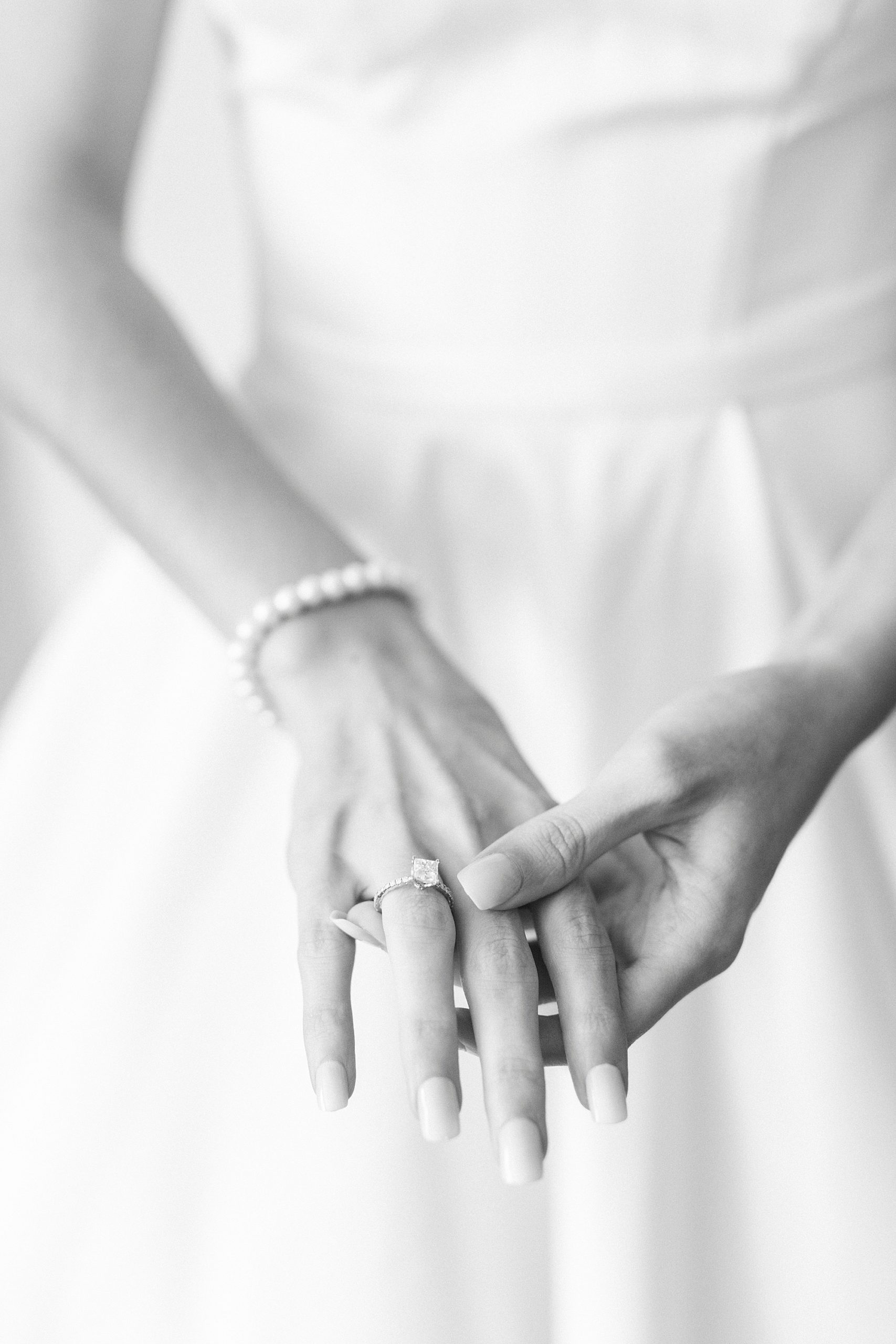 bride shows off pearl bracelet before NC wedding