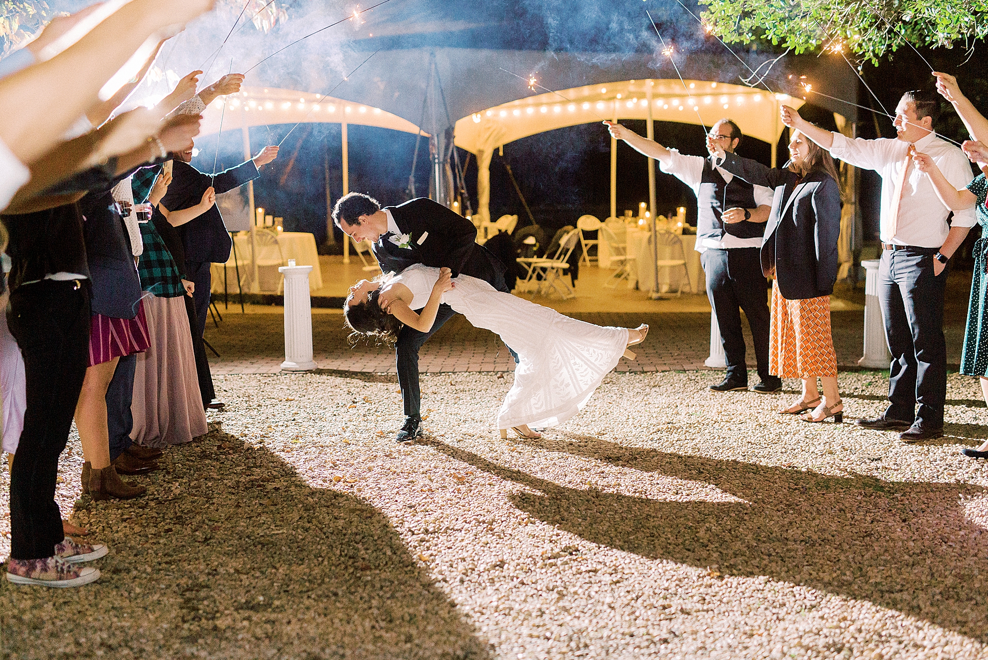 groom dips bride during sparkler exit at 1812 Hitching Post
