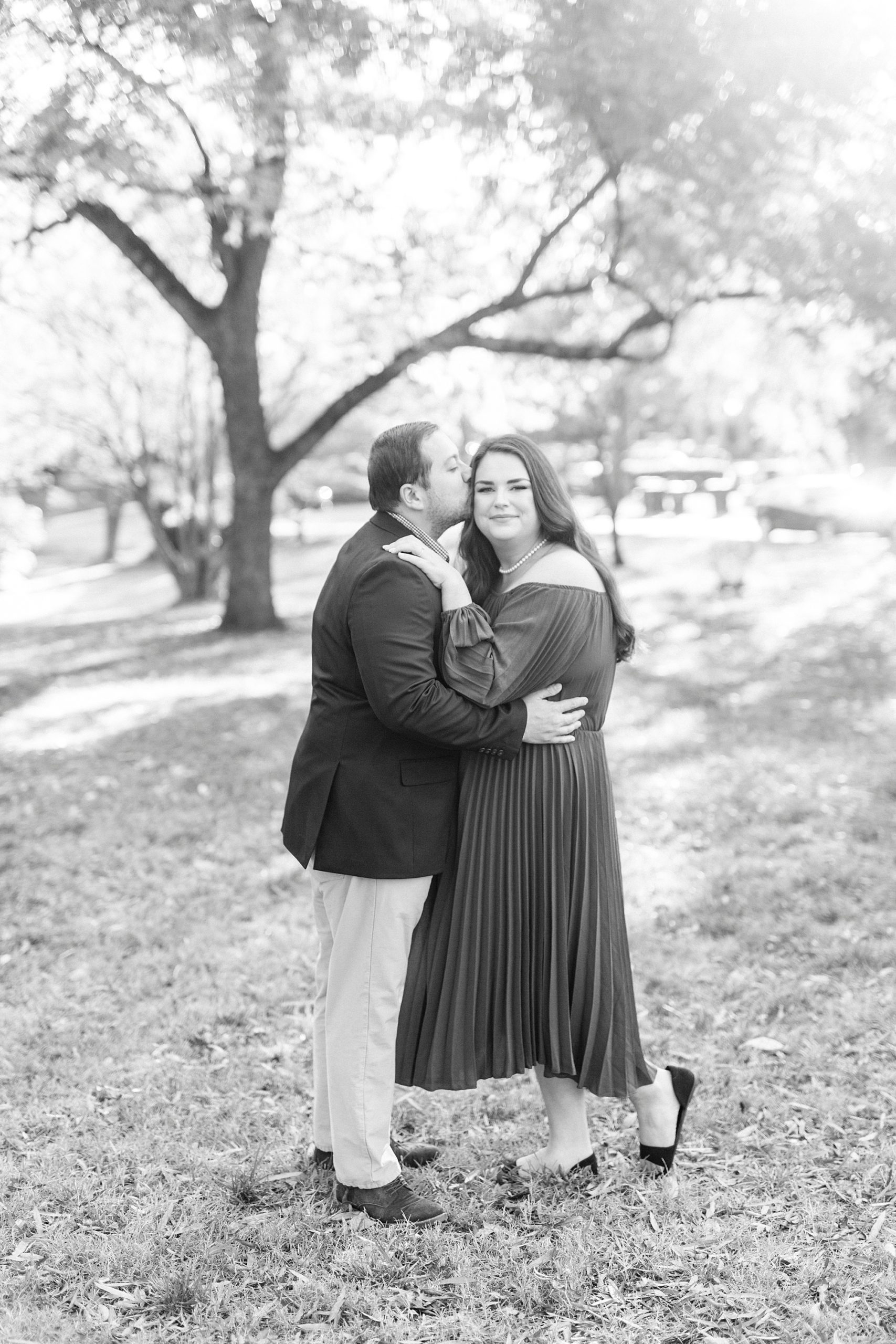 groom kisses bride's forehead during NC engagement photos