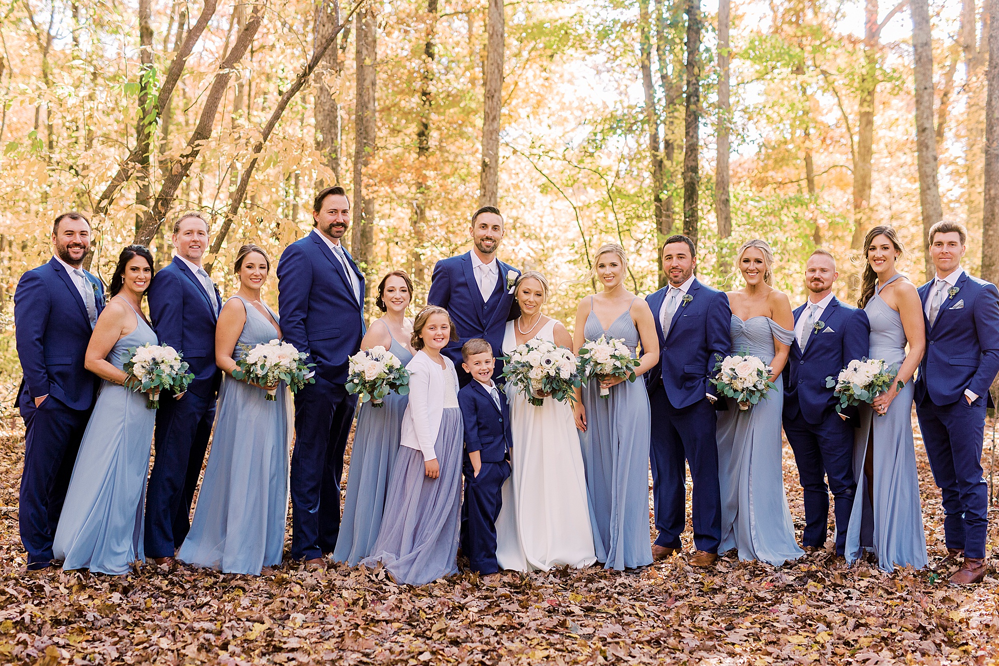 newlyweds stand with wedding party before Farm at Brusharbor wedding
