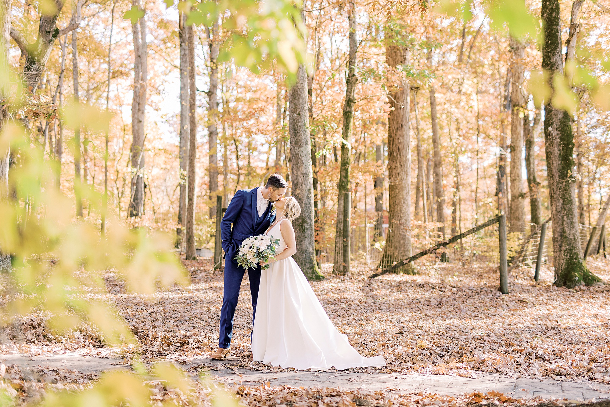bride and groom kiss in the woods at the Farm at Brusharbor