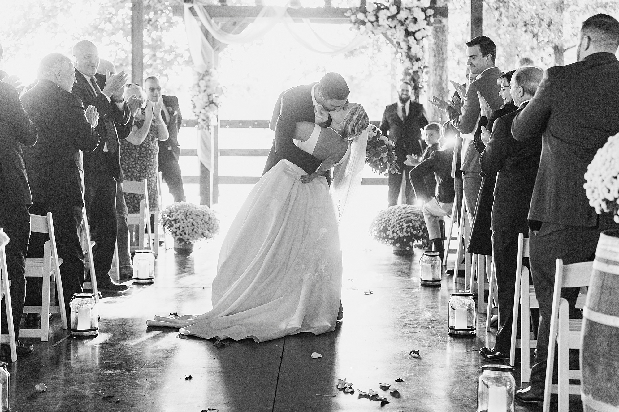 bride and groom kiss after wedding ceremony in aisle