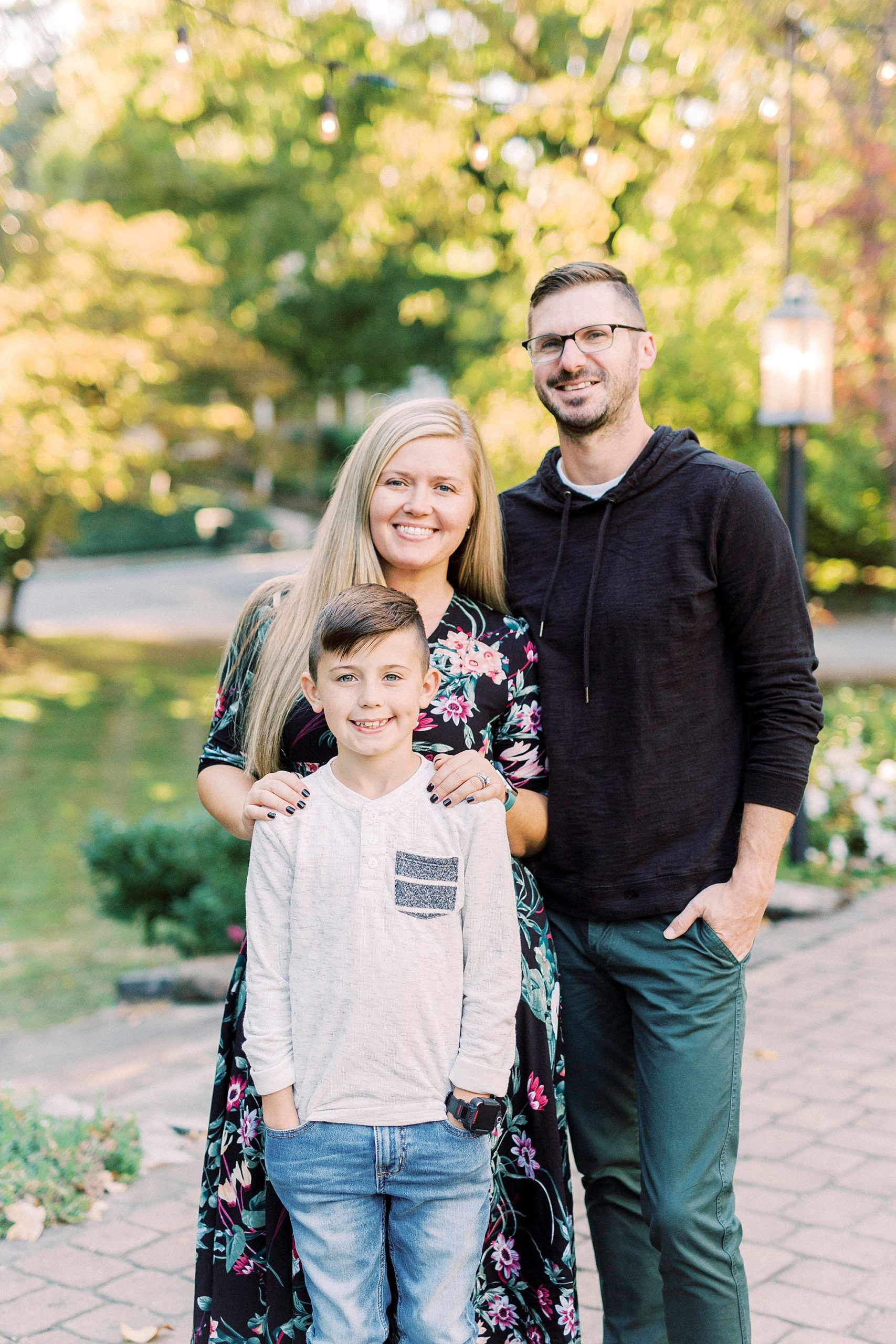 parents pose with son during Ritchie Hill family portraits on patio