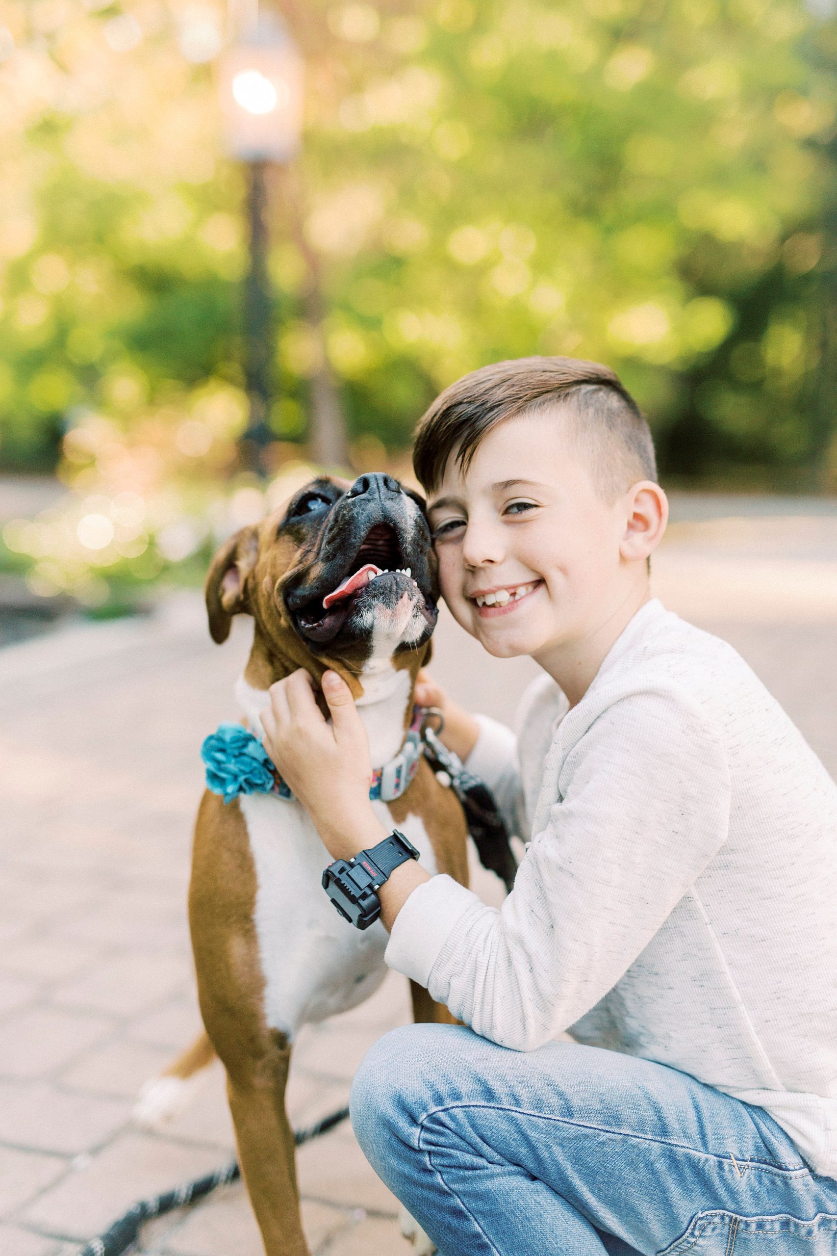 boy hugs dog during fall family photos at Ritchie Hill