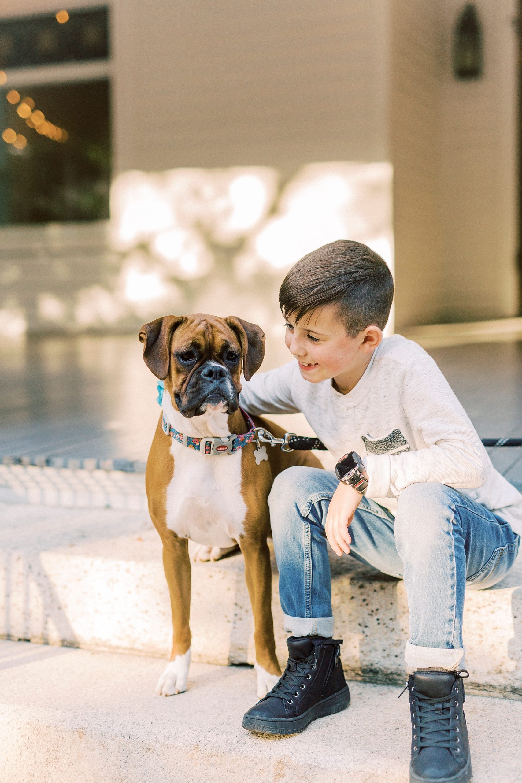 boy hugs dog during family photos in Concord NC