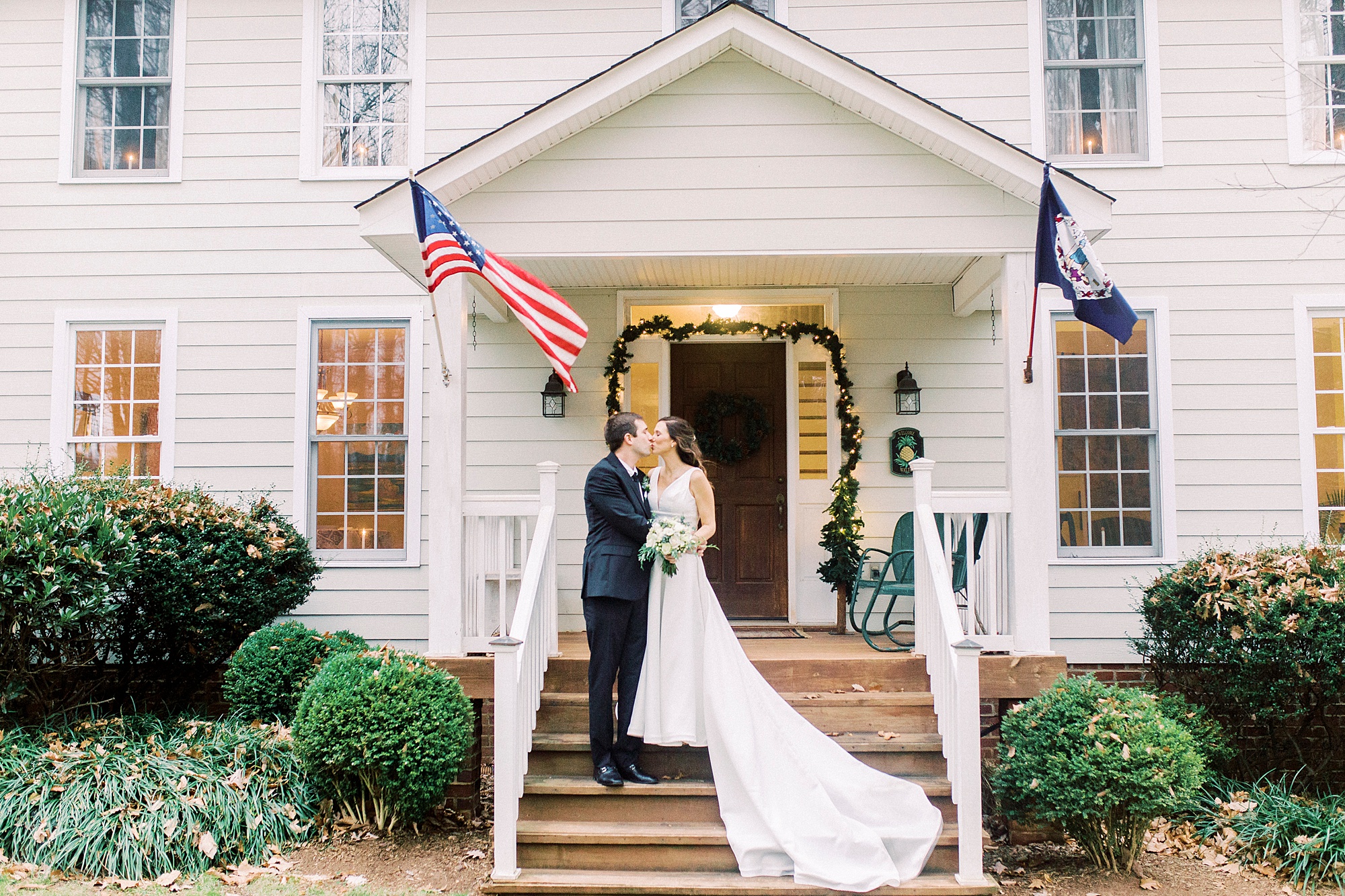 bride and groom kiss on steps in Bedford VA before winter wedding