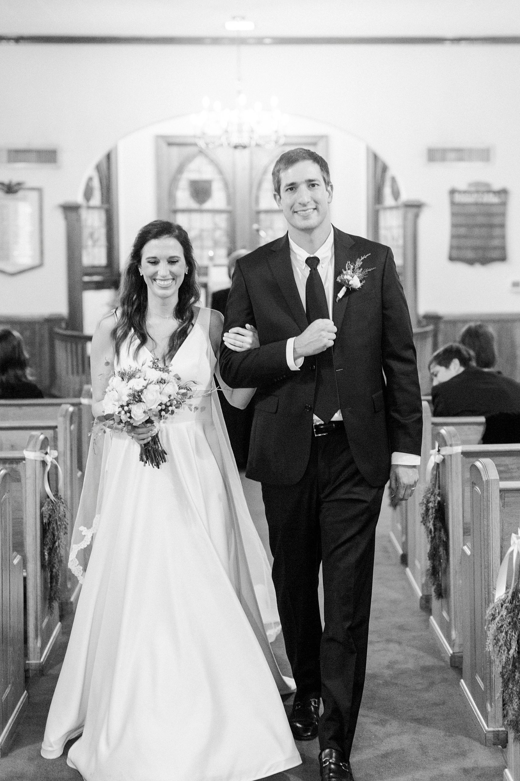 newlyweds walk up aisle after intimate church wedding at Bethesda United Methodist Church