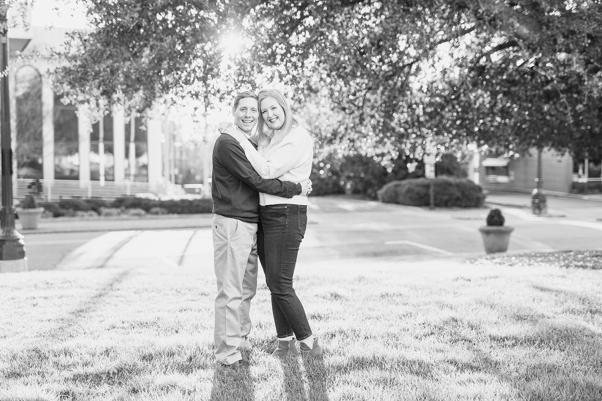 engaged couple poses in Downtown Concord park at sunset