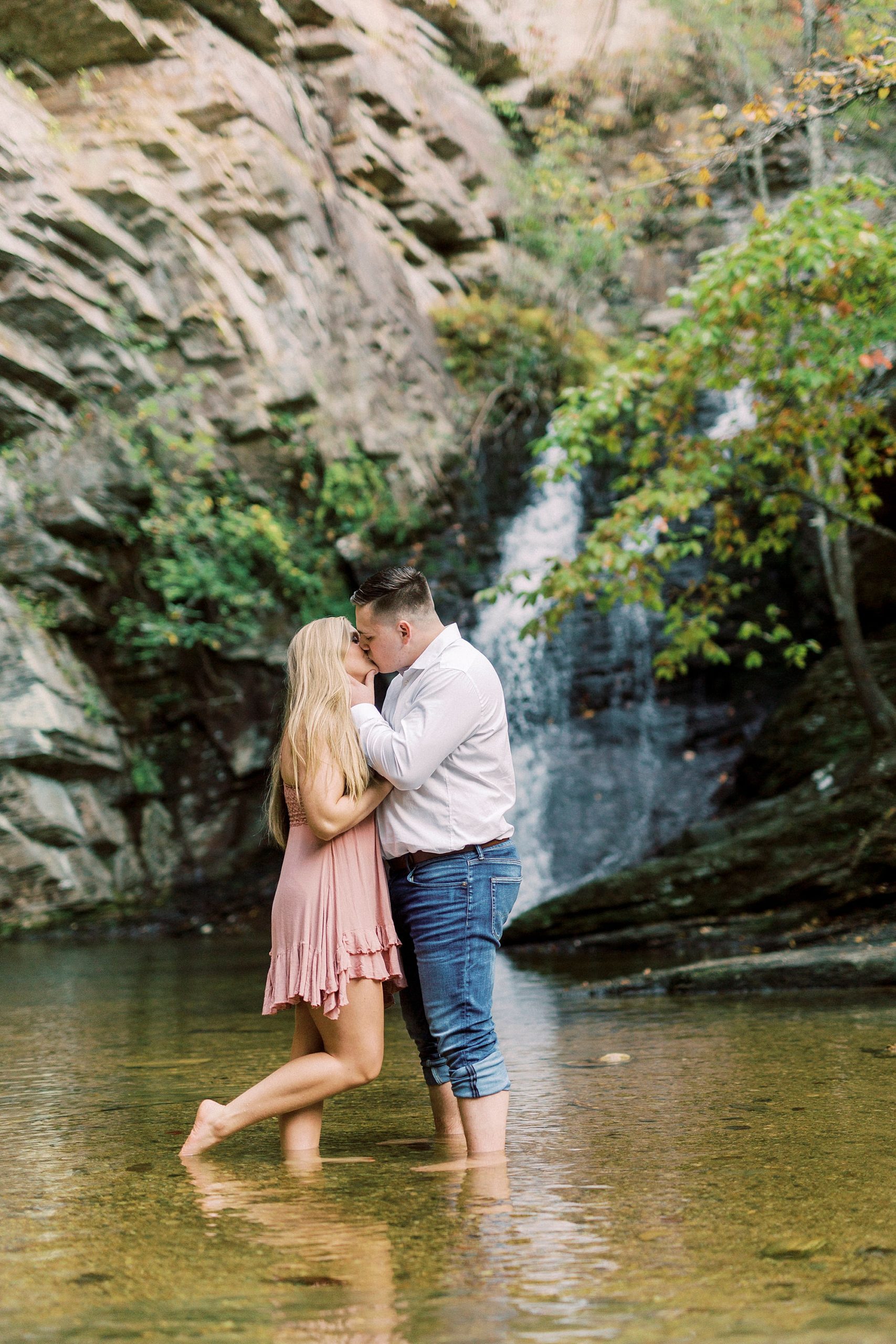 bride and groom stand in water at Hanging Rock State Park