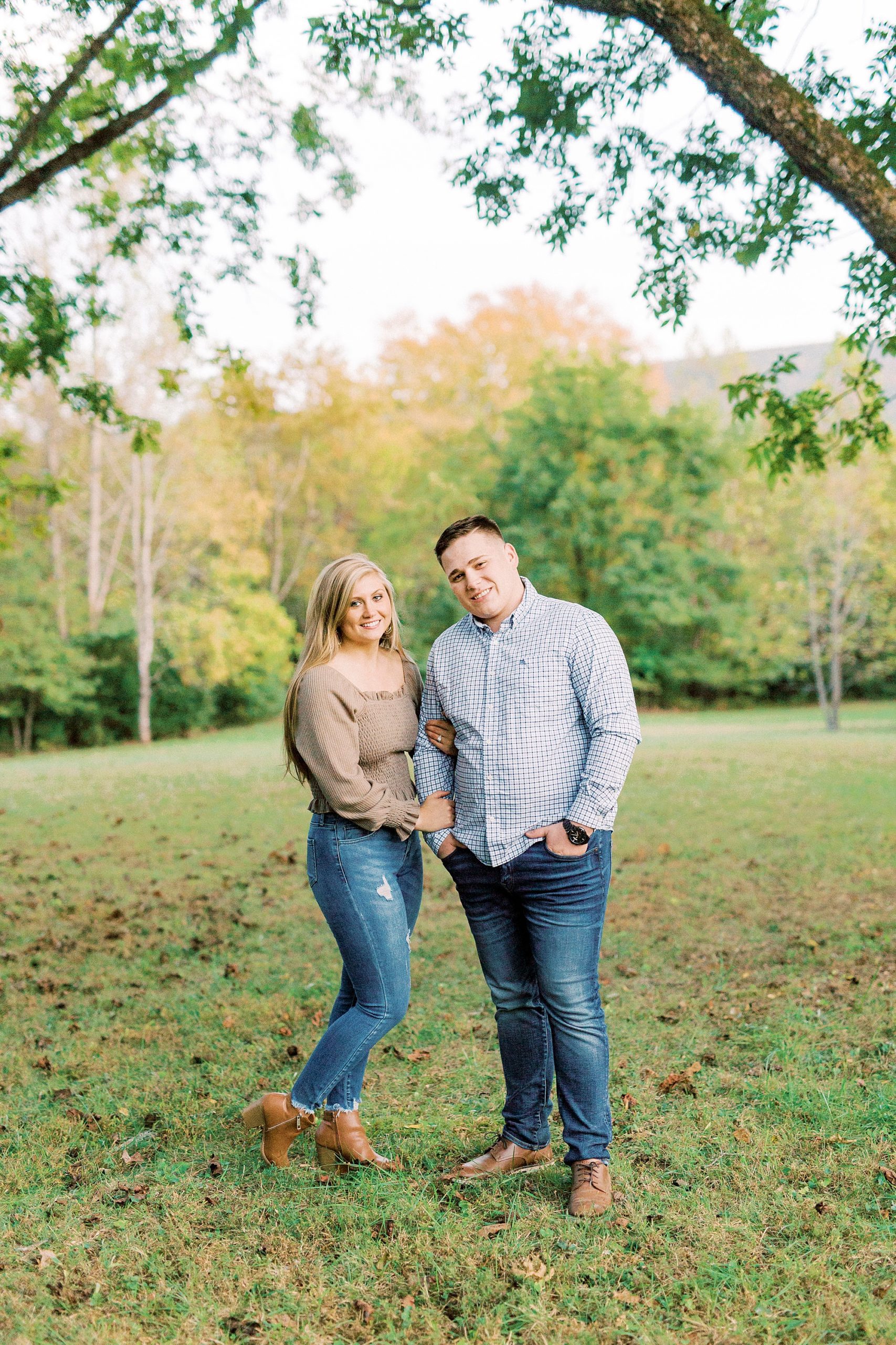 bride and groom pose together during fall engagement session