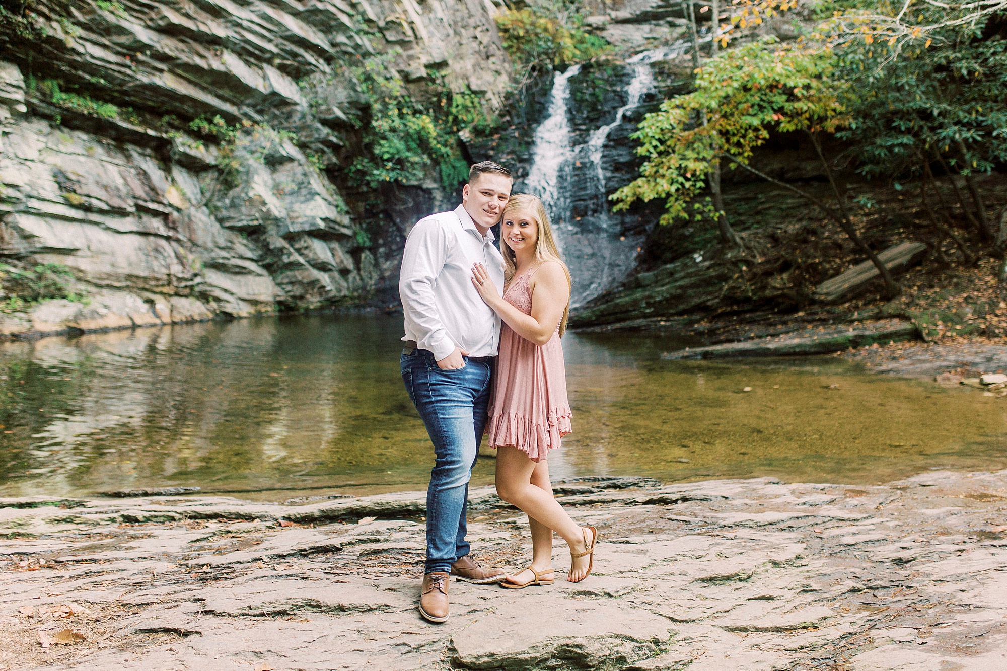 engaged couple stands together during adventurous engagement photos in NC