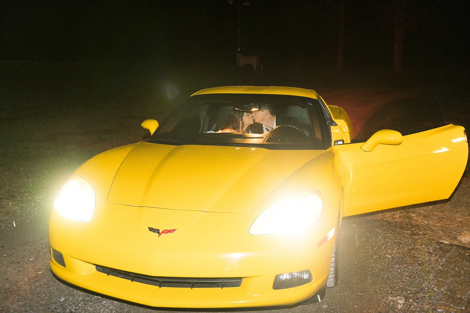 bride and groom kiss in yellow getaway car at The Farm at Brusharbor