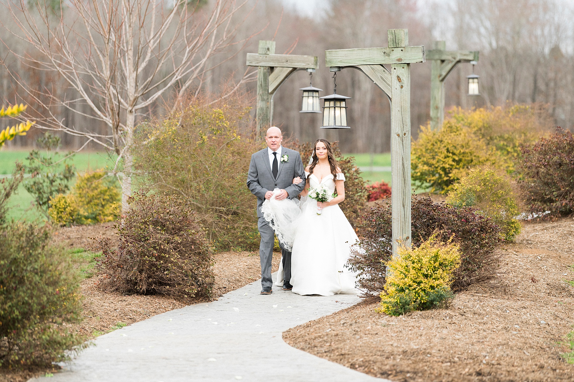 bride walks into wedding ceremony with dad