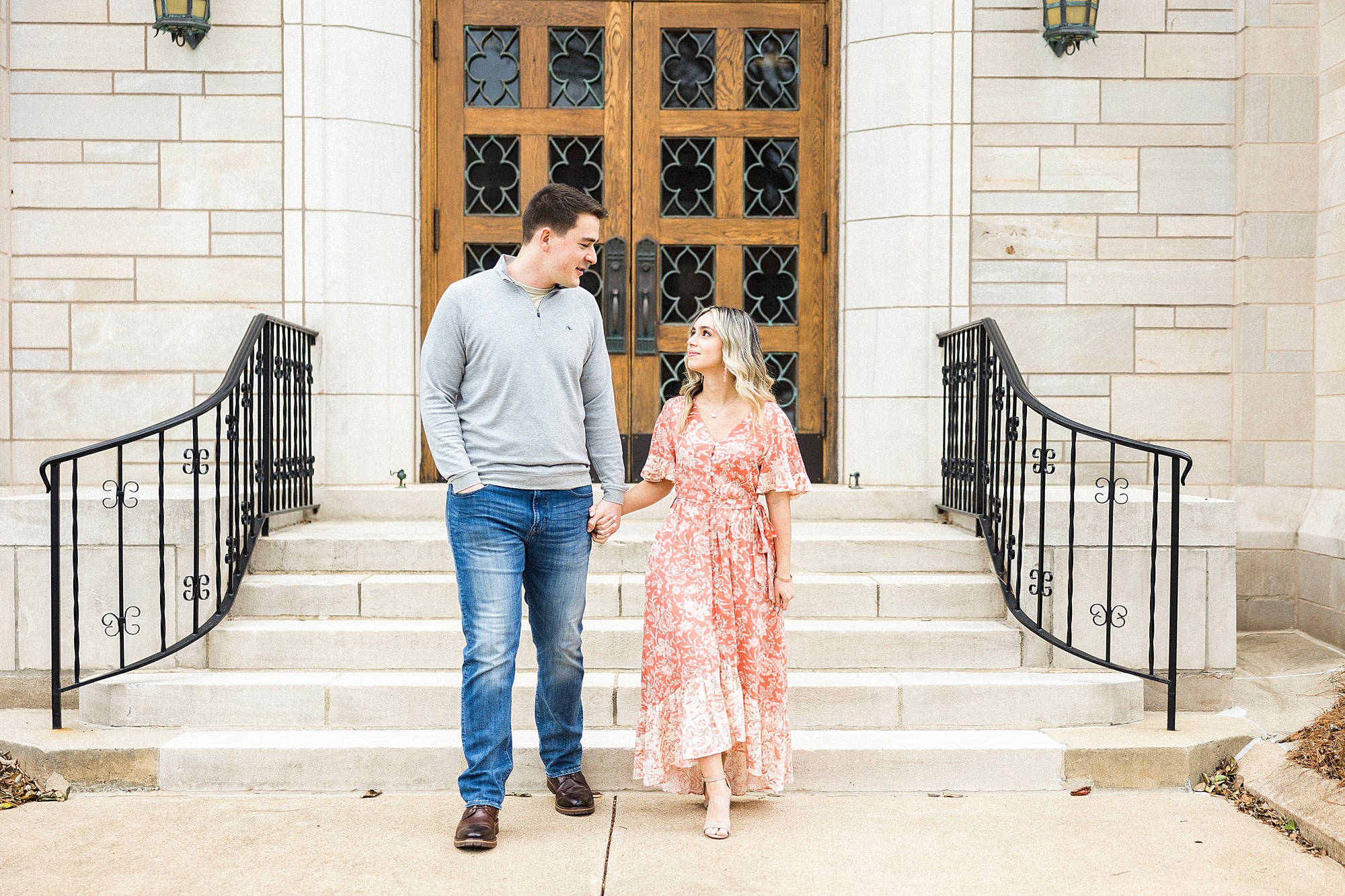 engaged couple walks down steps at St. James Lutheran Church
