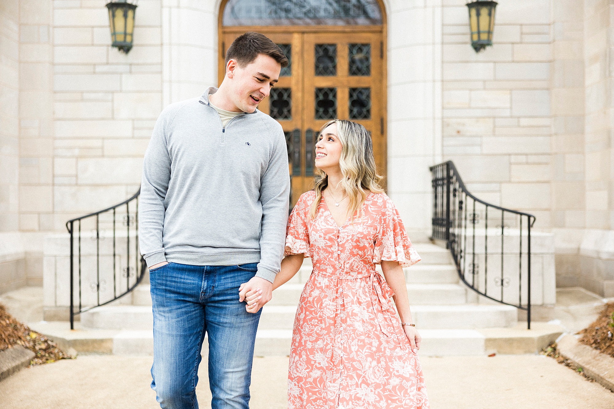 couple walks together down steps during Downtown Concord engagement session