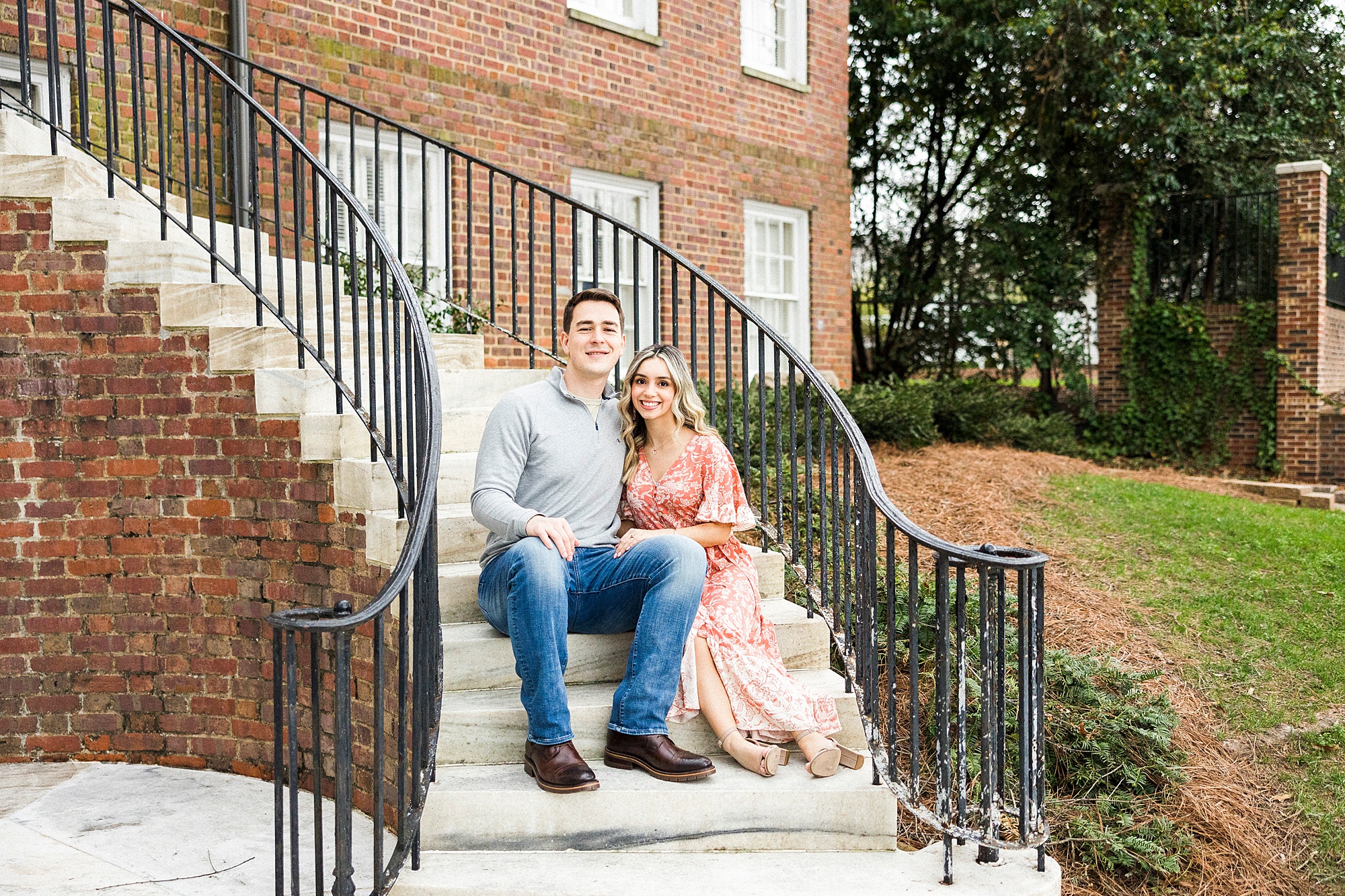 couple sits on steps during Downtown Concord engagement session