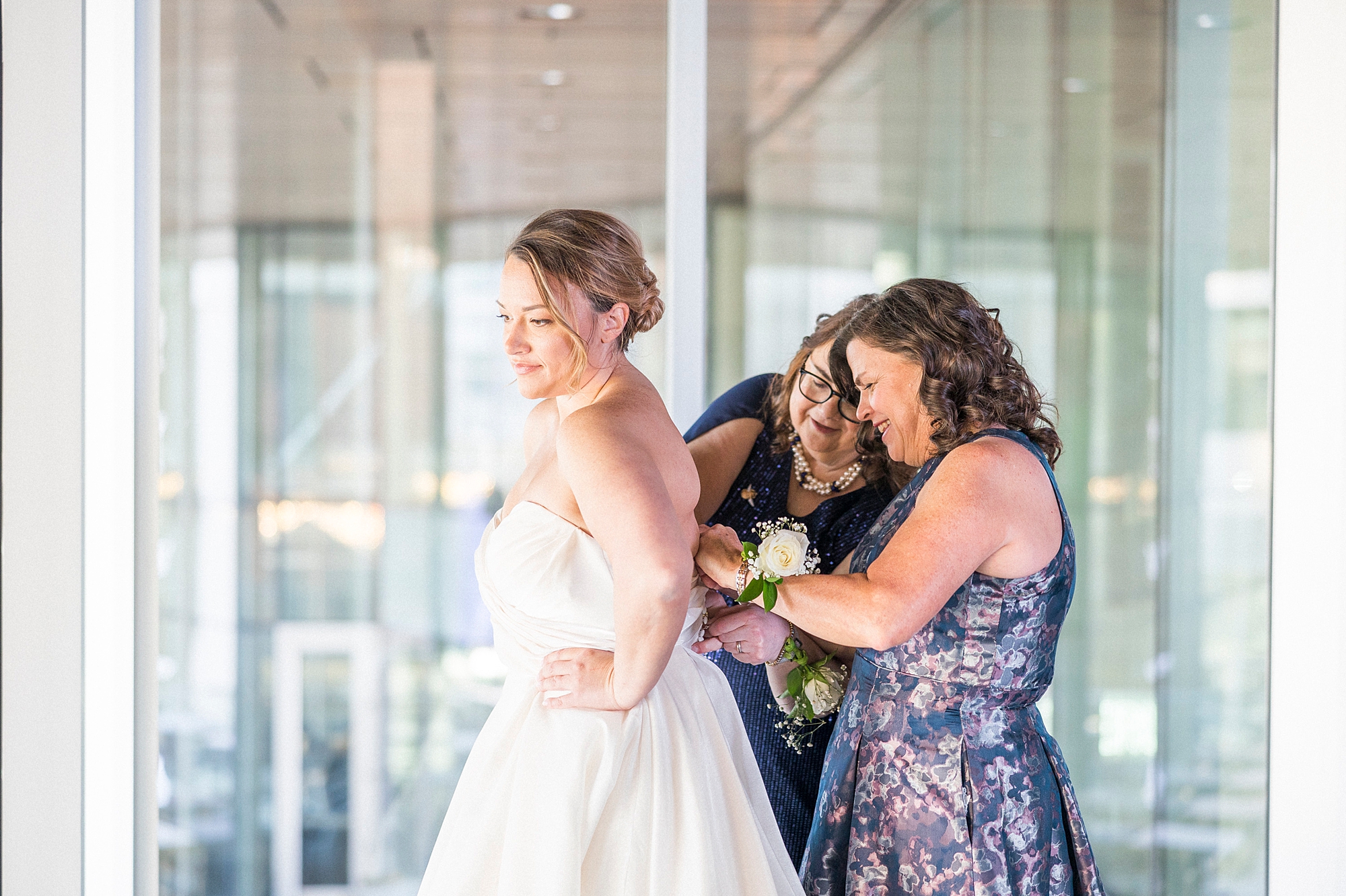 women help bride int wedding dress in Charlotte NC