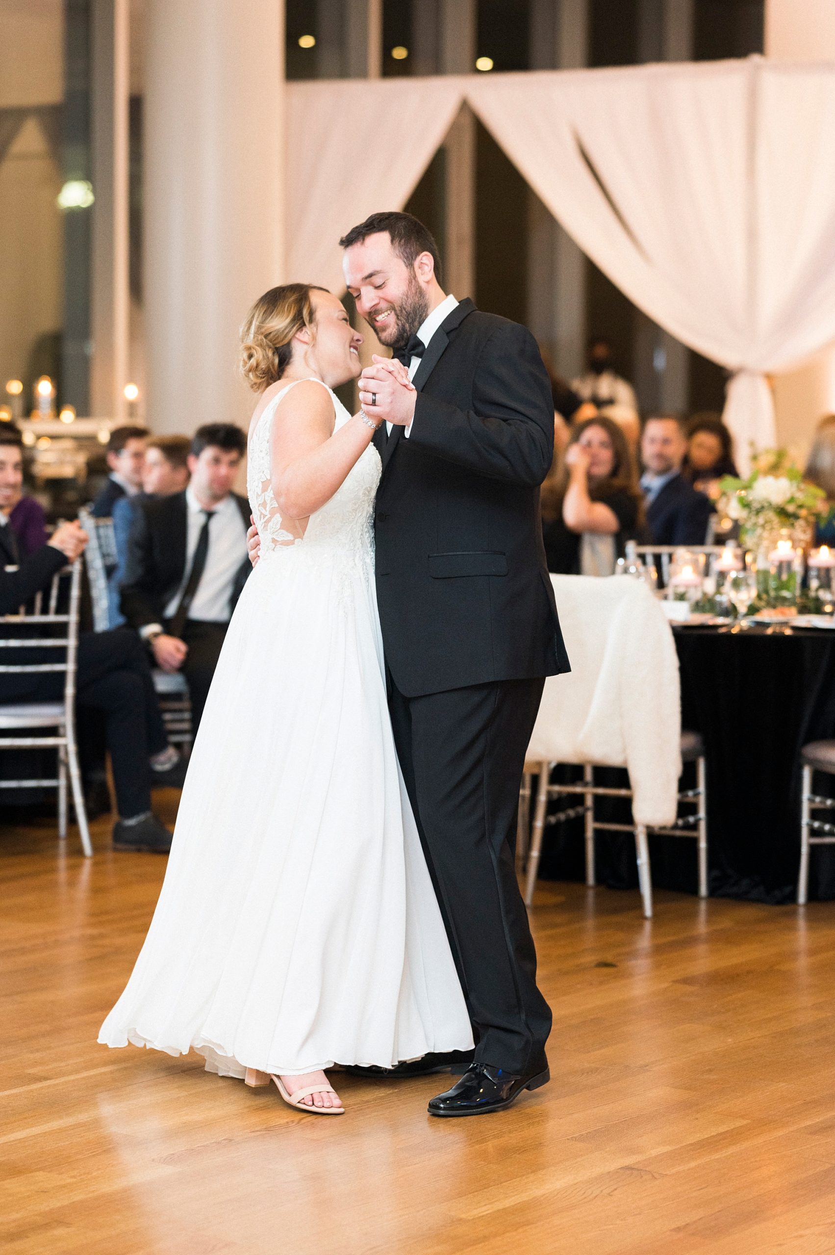 bride and groom dance together at Mint Museum Uptown