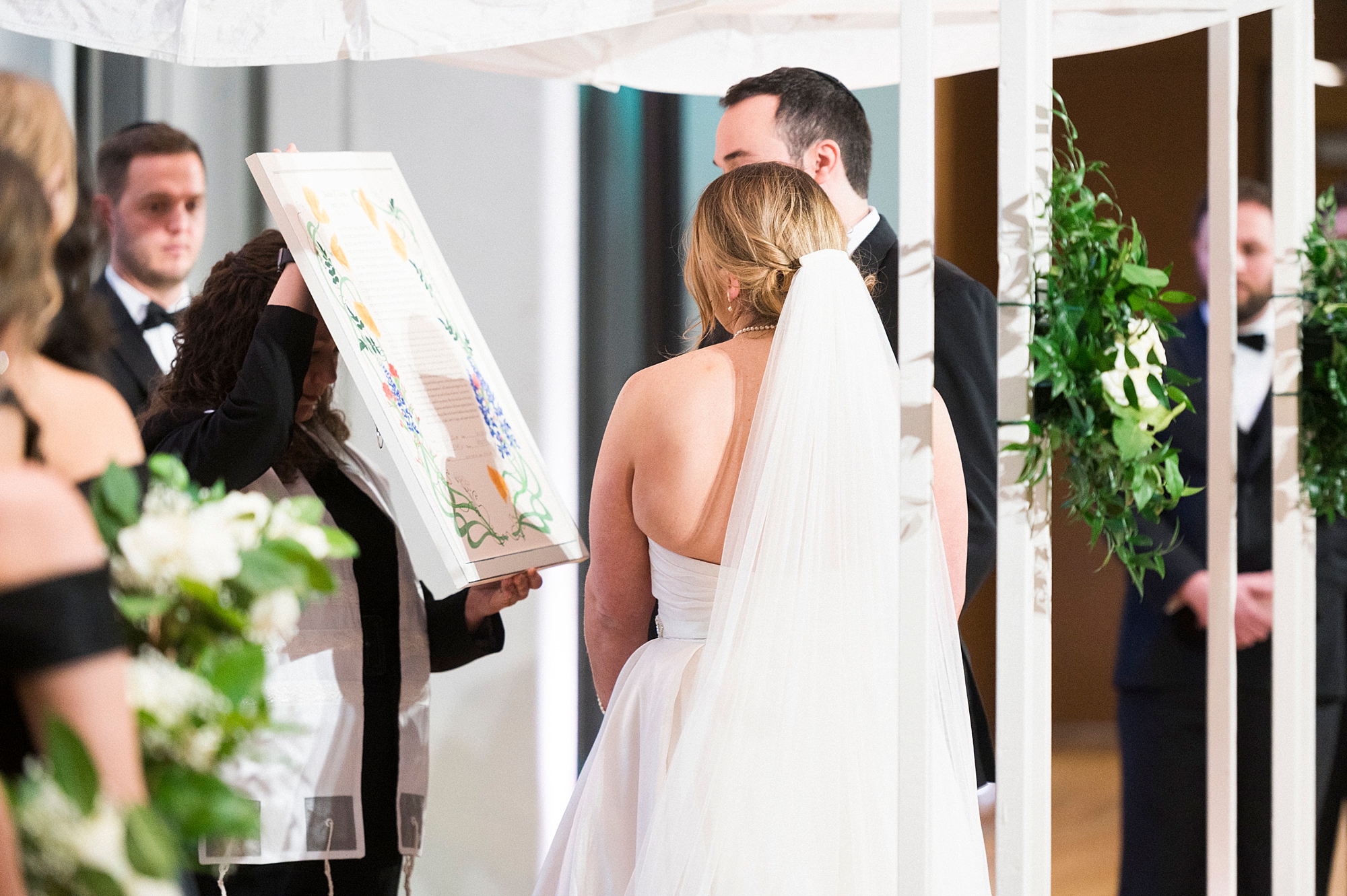 couple looks at painting from wedding reception at the Mint Museum Uptown