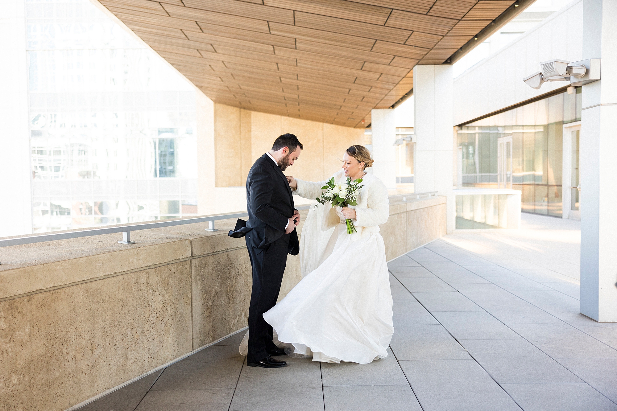 bride and groom have first look before Mint Museum Uptown wedding