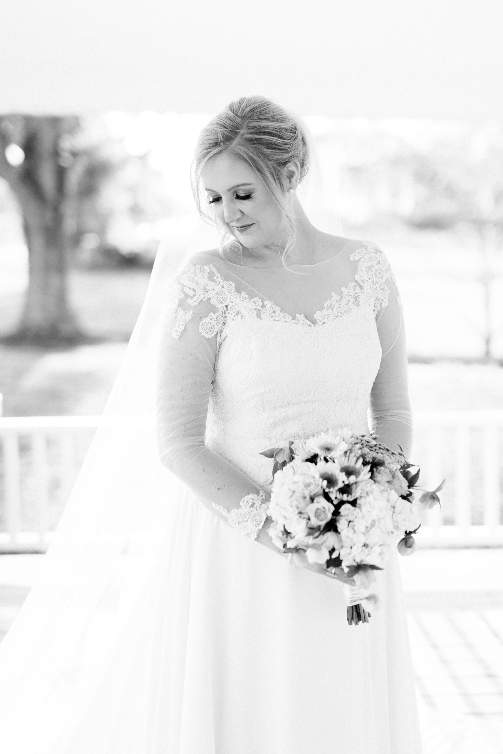 bride looks over shoulder during bridal session in custom wedding gown