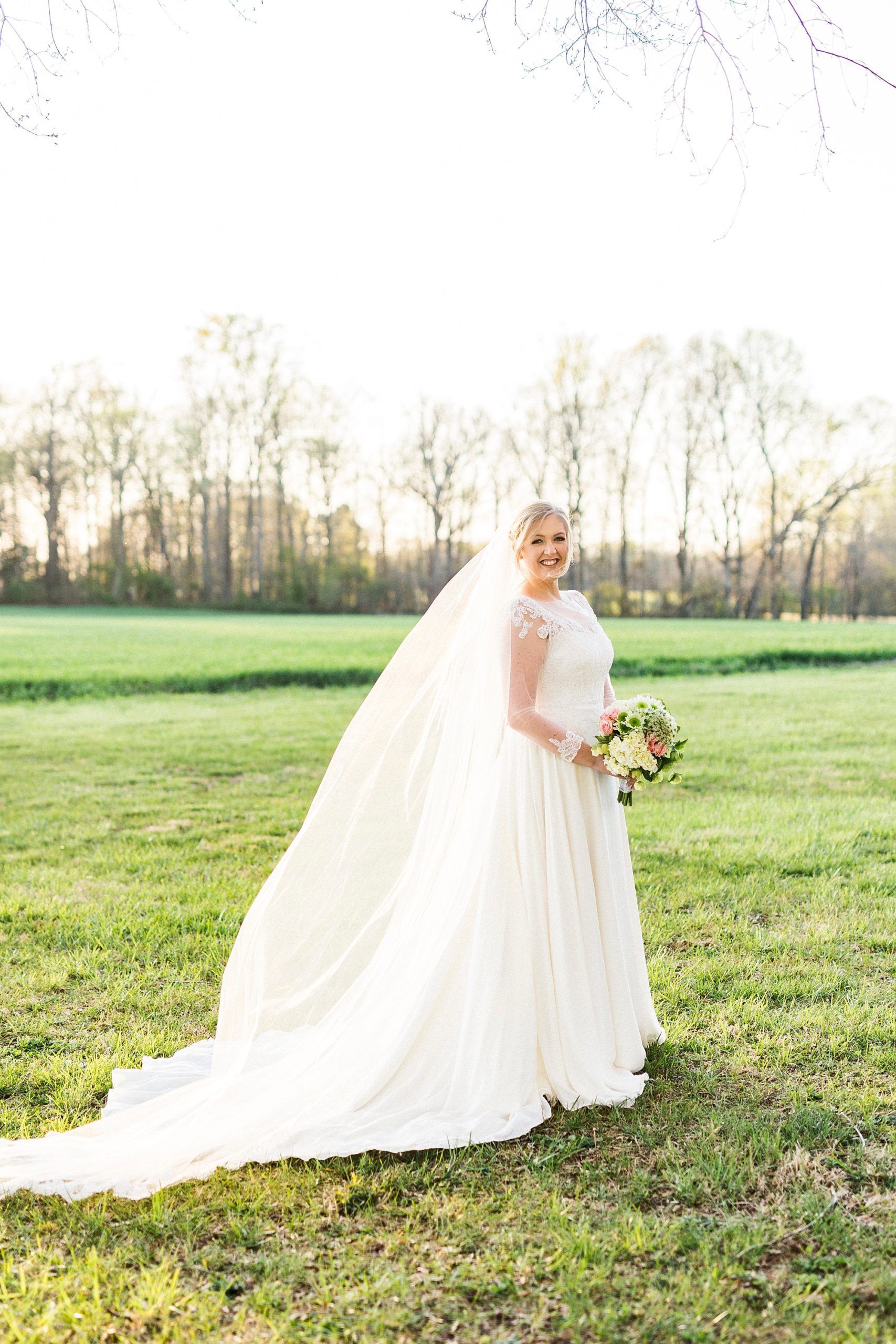 bride walks through field during Mooresville bridal portraits