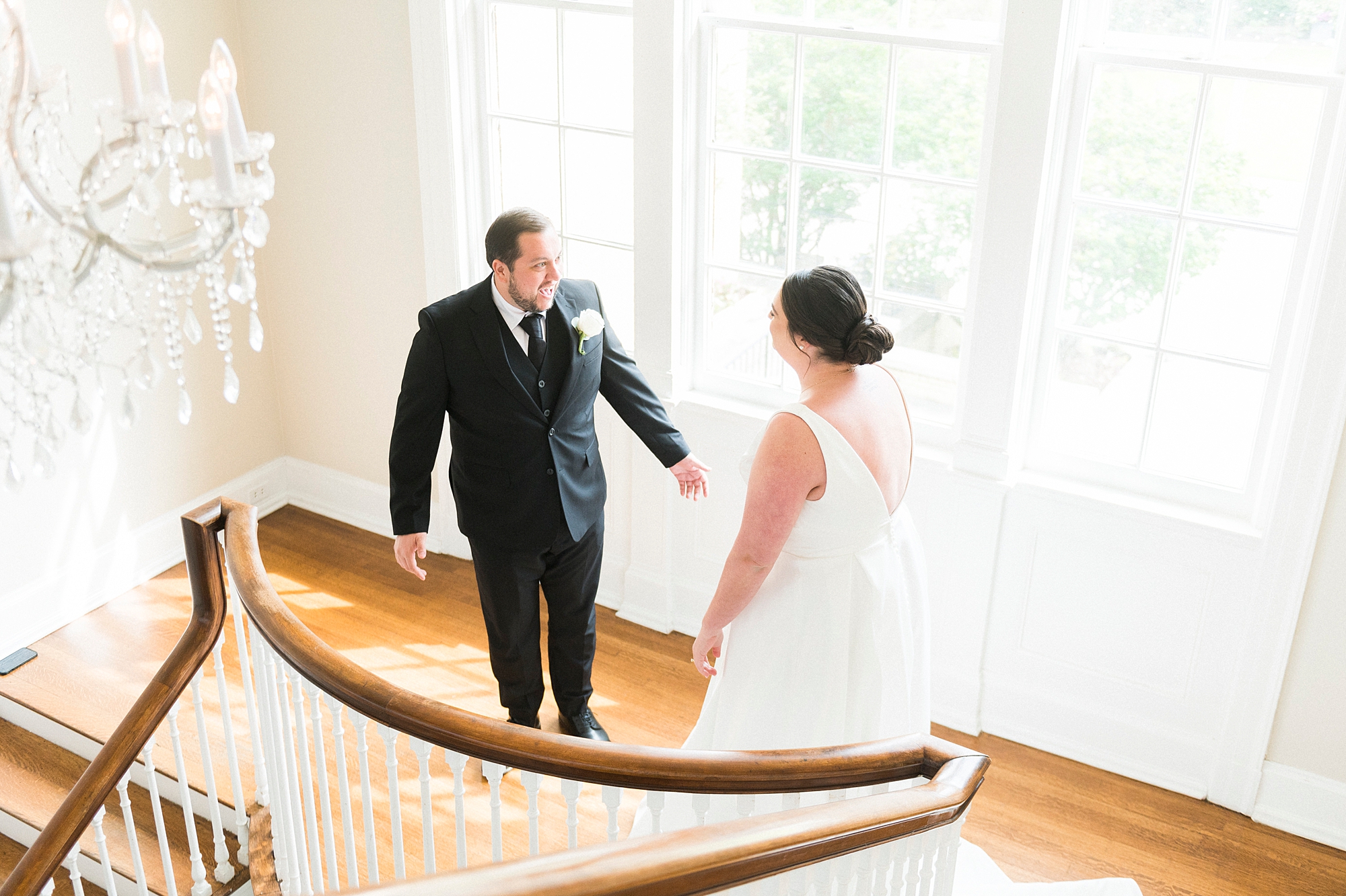 bride and groom have first look on staircase at the Separk Mansion