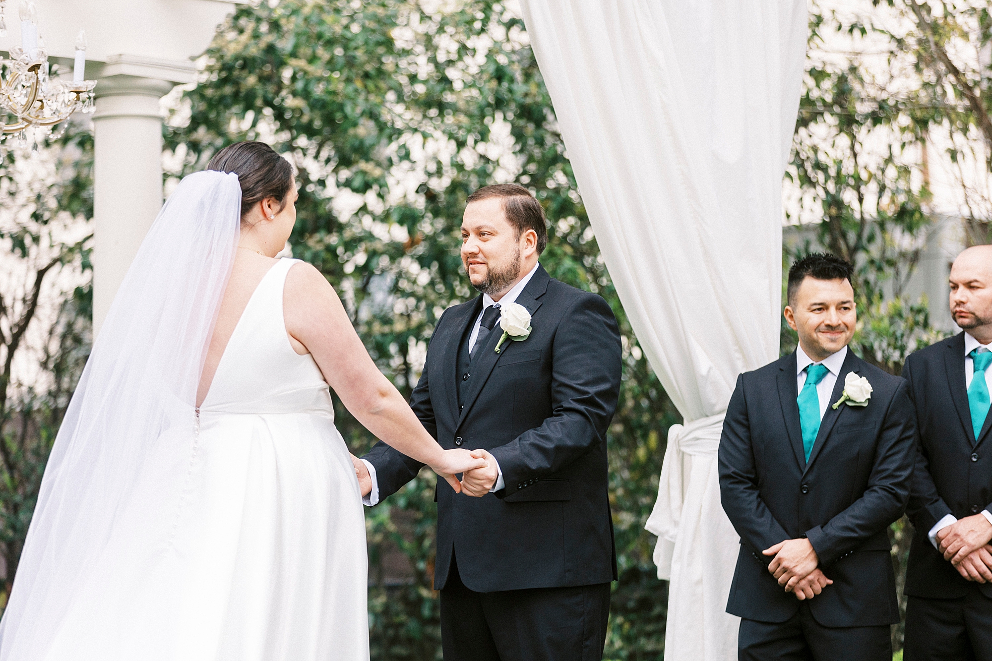 couple holds hands during outdoor ceremony at the Separk Mansion
