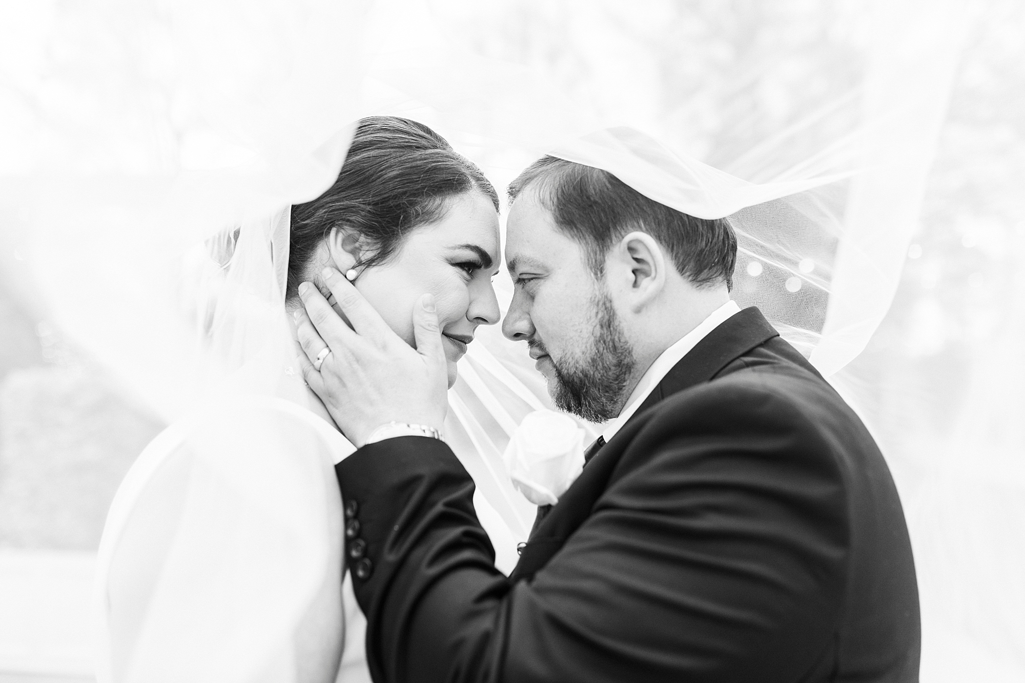 bride and groom pose under veil at Separk Mansion