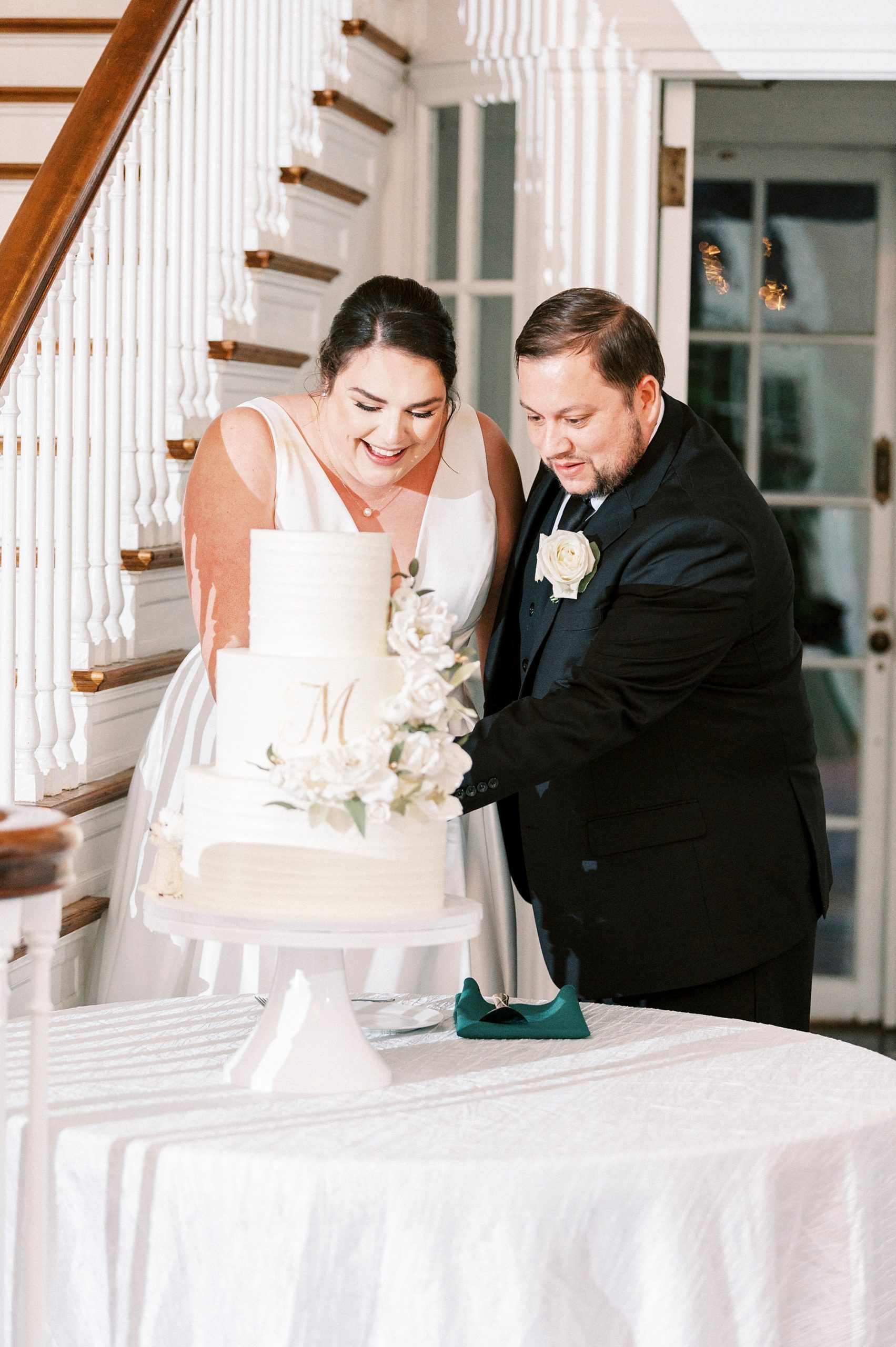 bride and groom cut wedding cake during spring Separk Mansion wedding reception