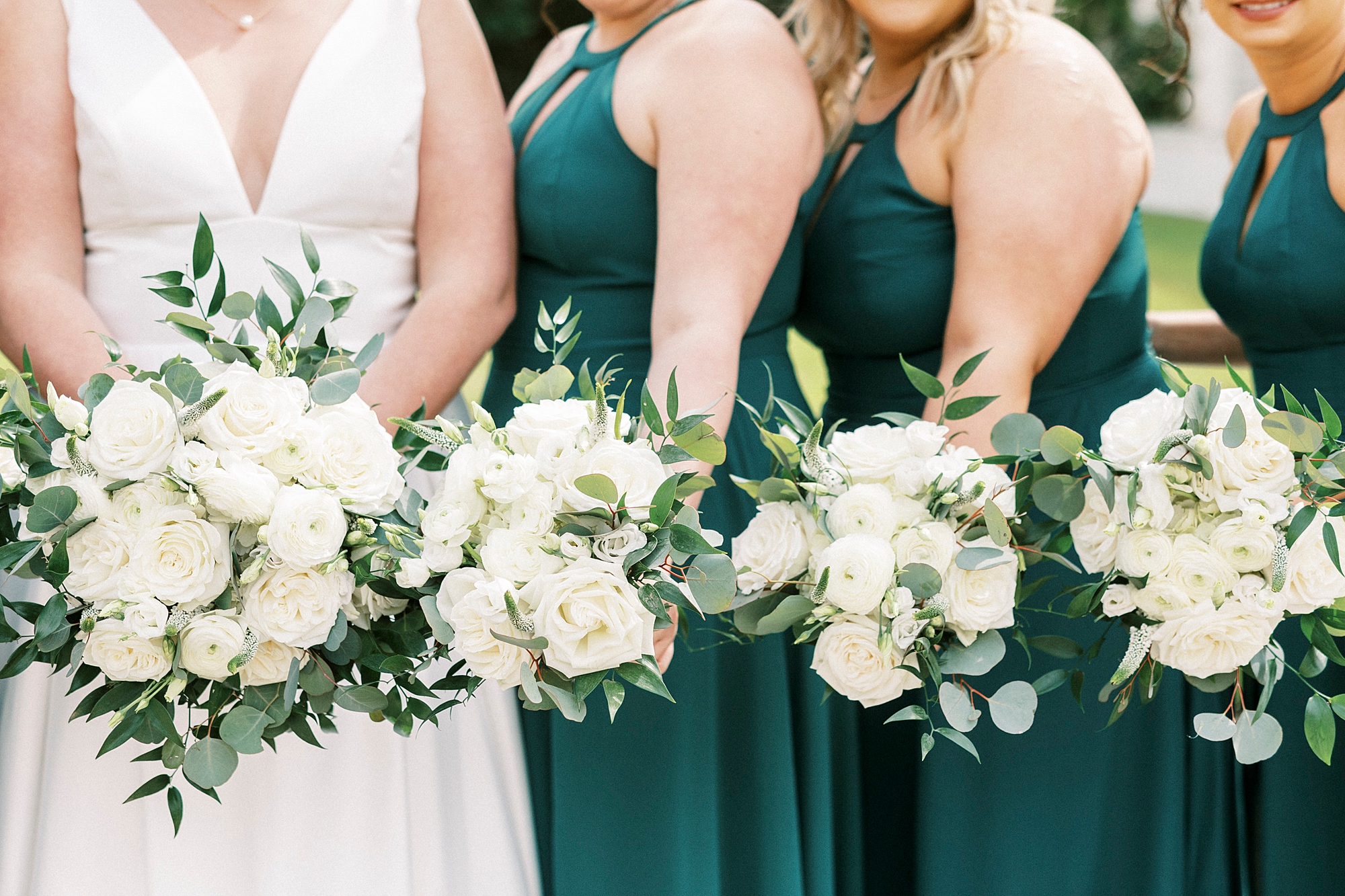 bride and bridesmaids hold all white bouquets for spring wedding at Separk Mansion