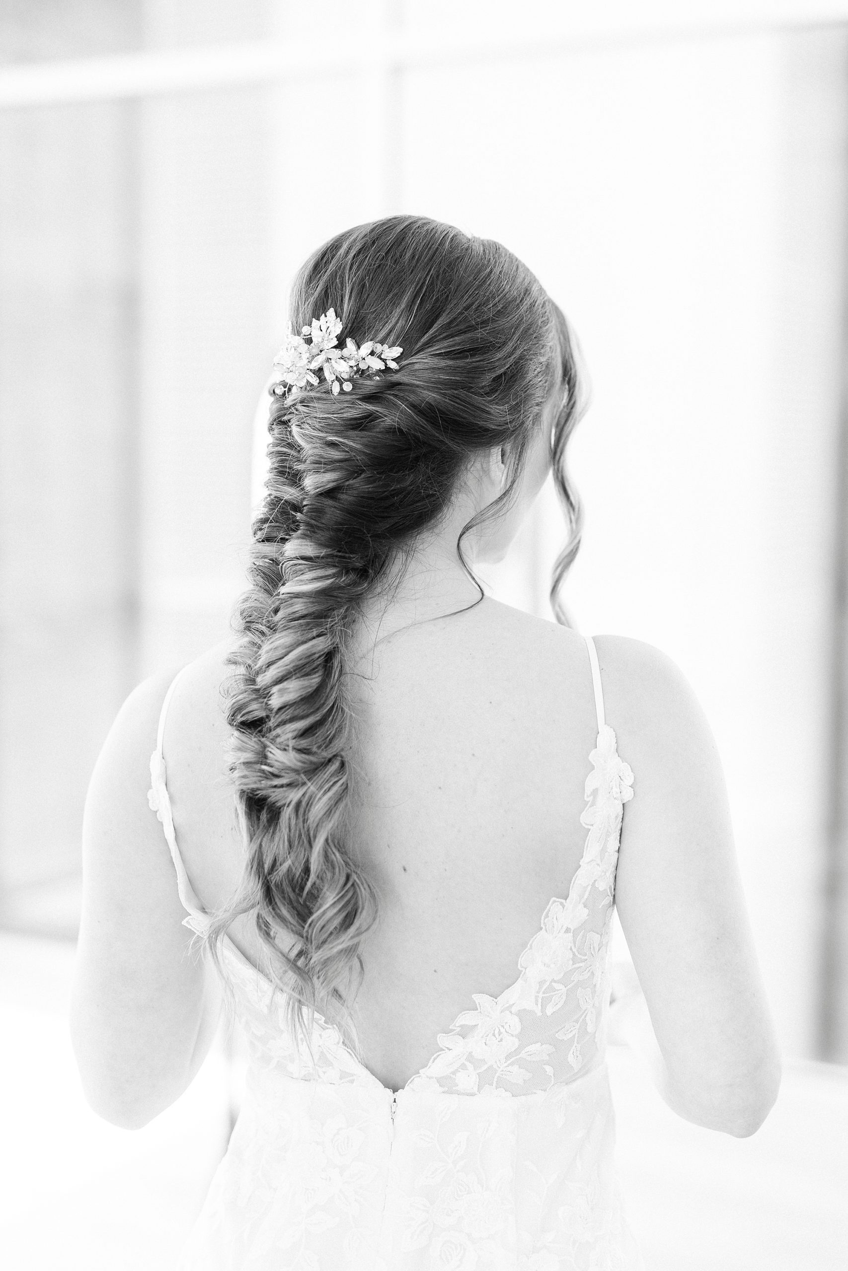 bride shows off fishtail hair for wedding day