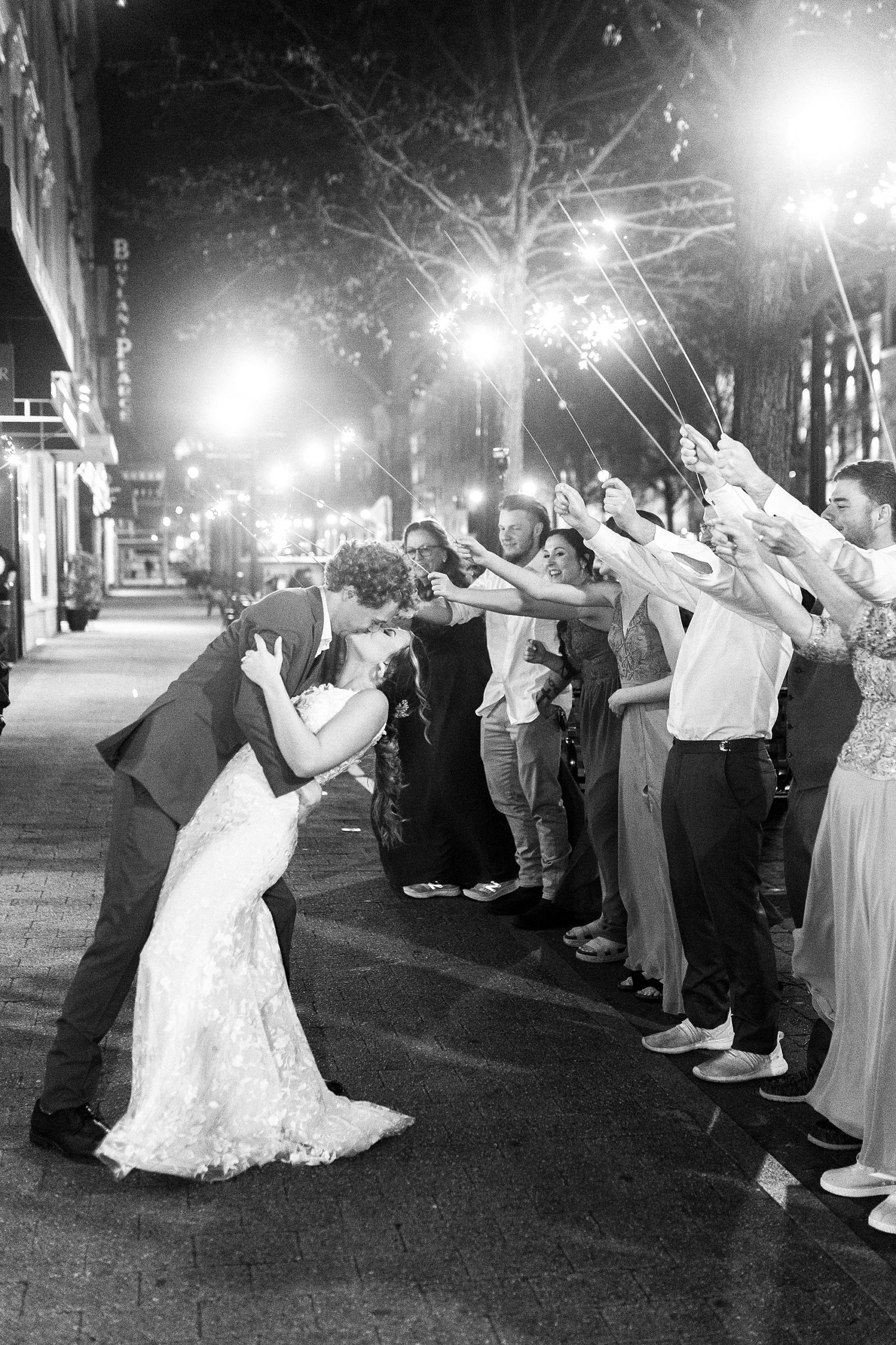 groom dips bride during sparkler exit at the Stockroom at 230