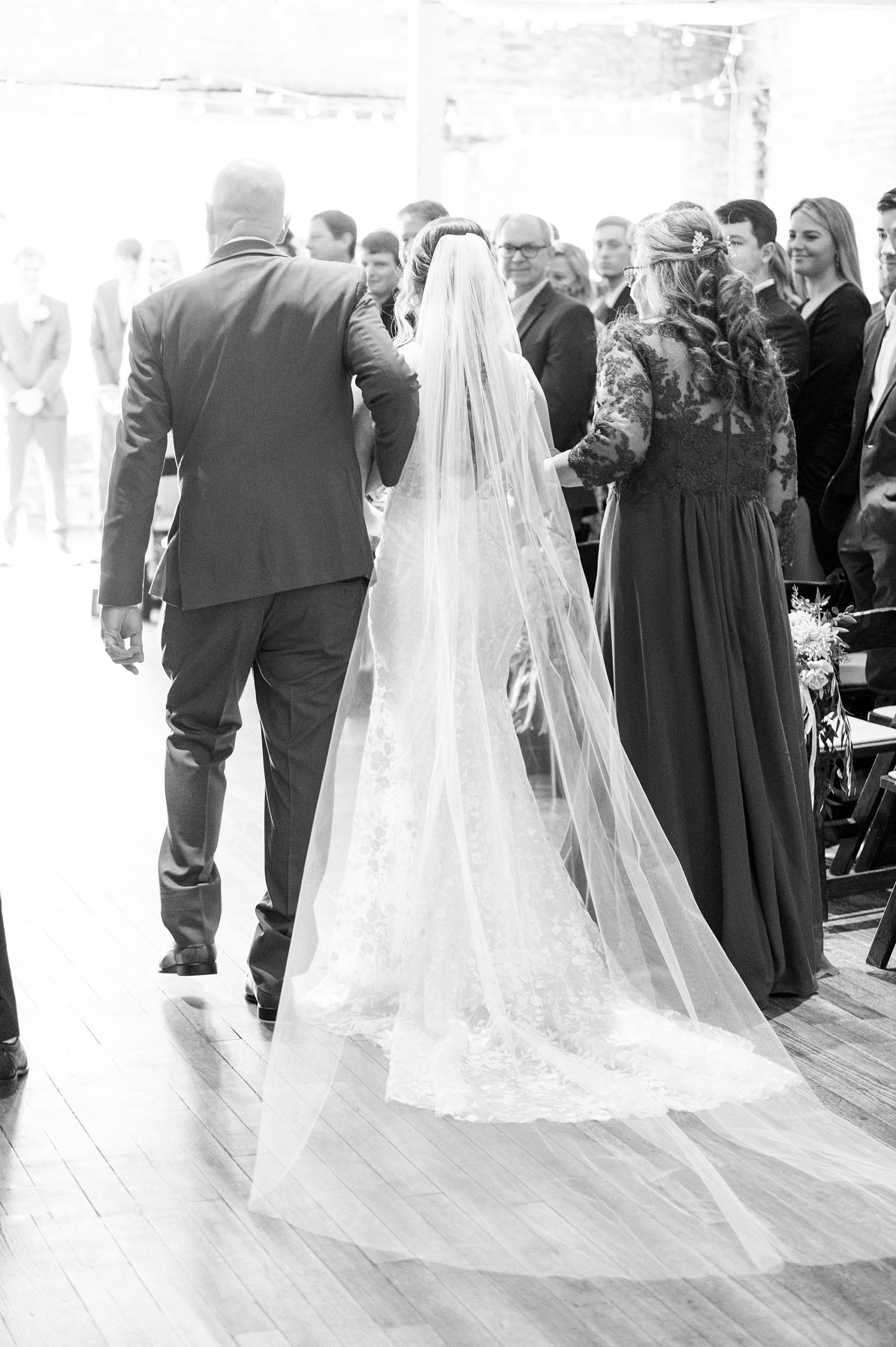 bride walks down aisle with both parents