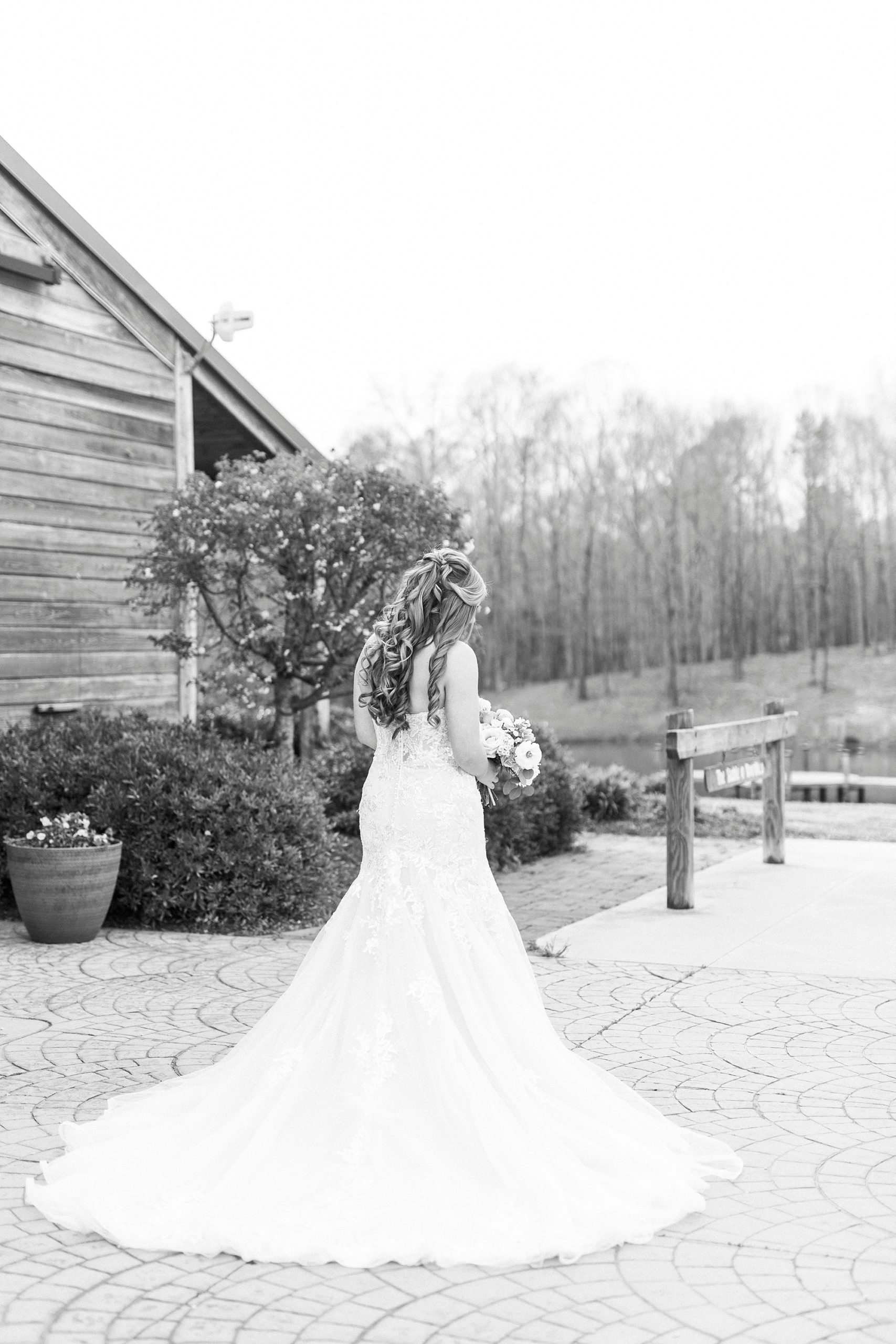 bride walks on brick patio at The Stable at Riverview