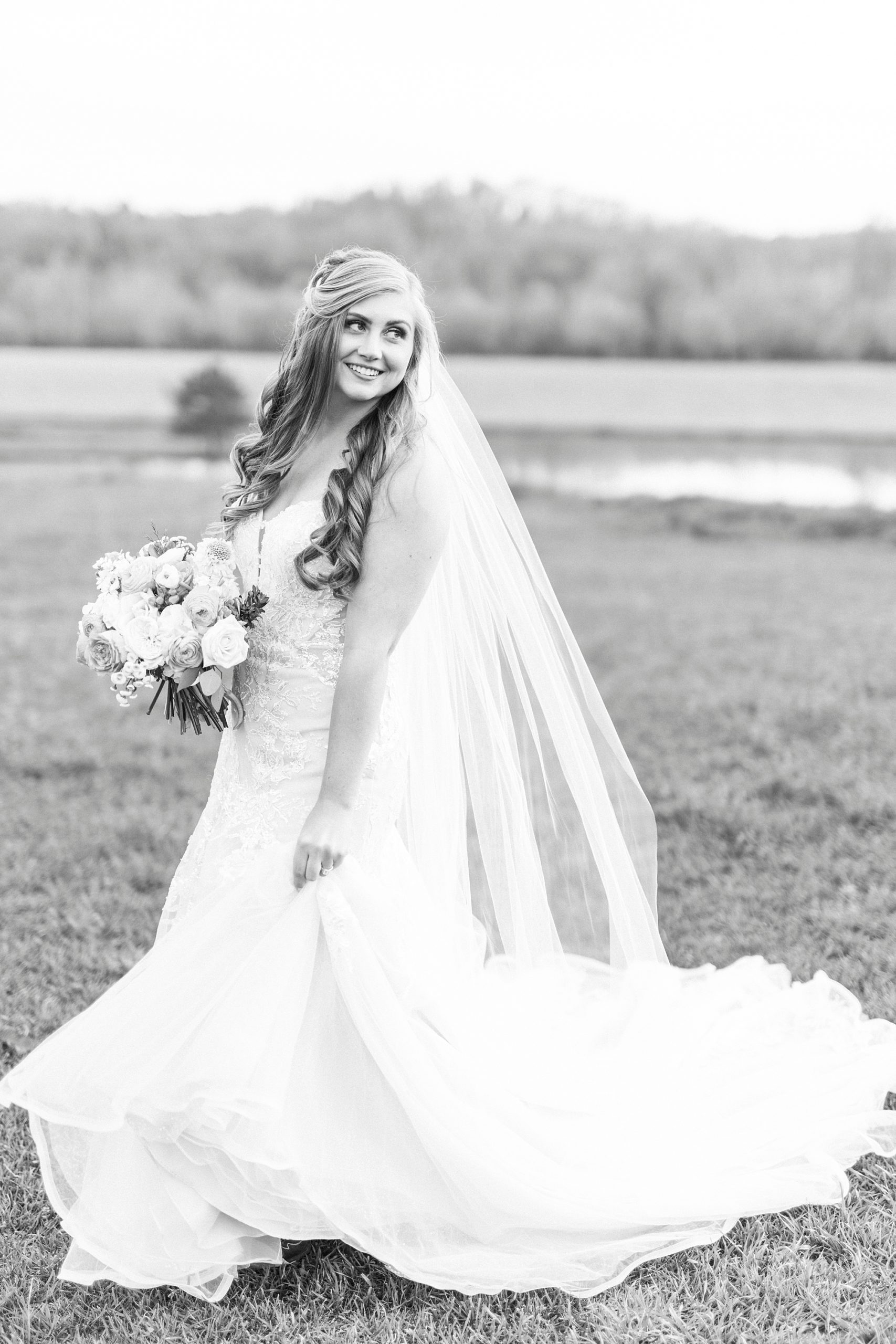 bride smiles twirling wedding gown on farm