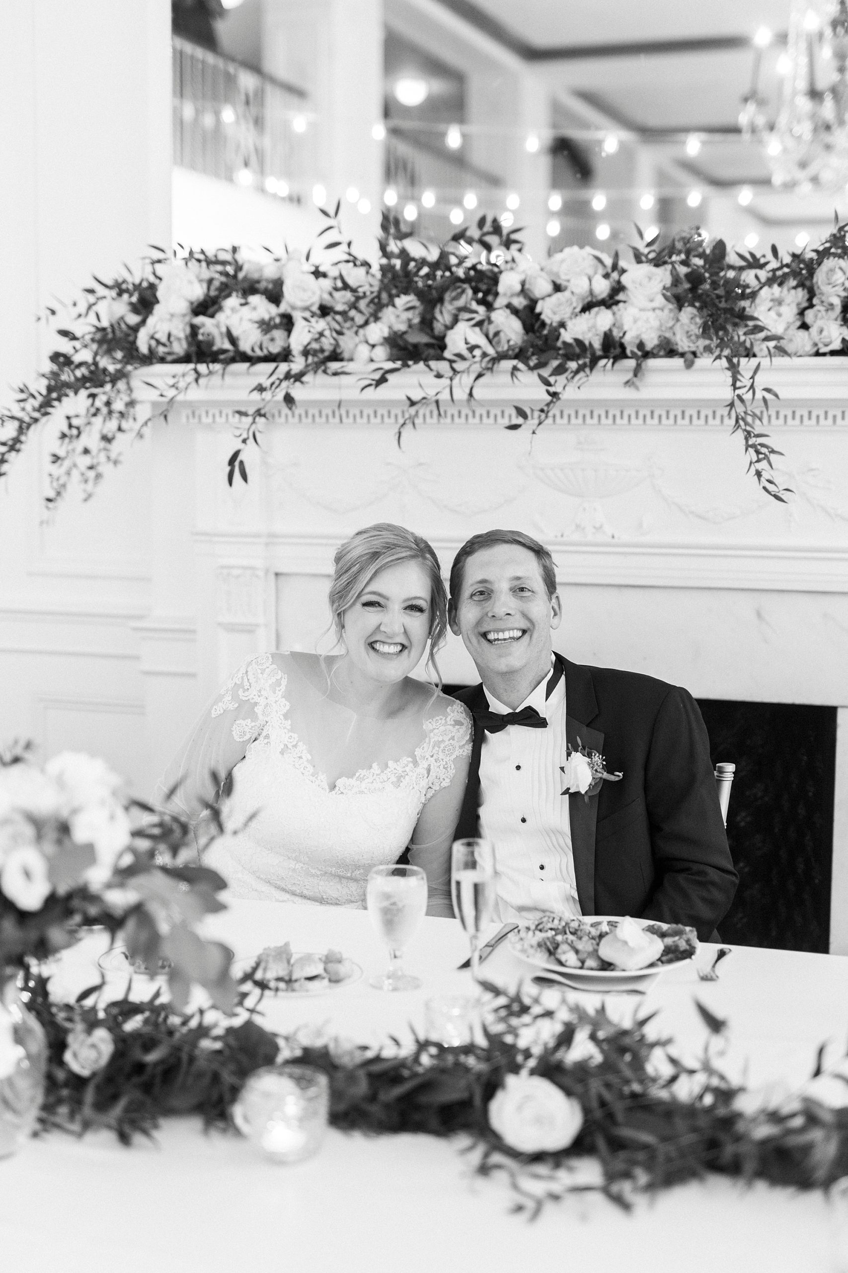 couple sits at sweetheart table during Concord NC wedding reception