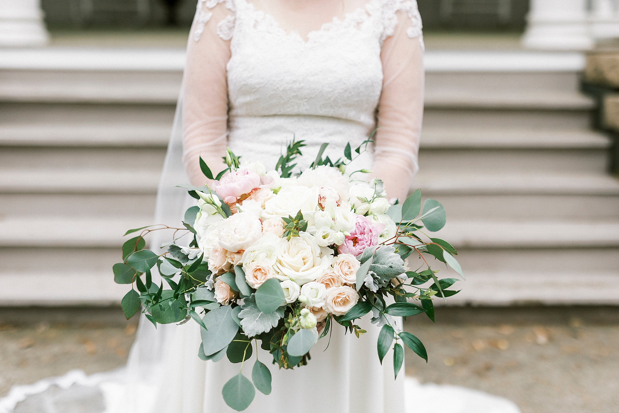 bride holds spring bouquet of pink and white flowers