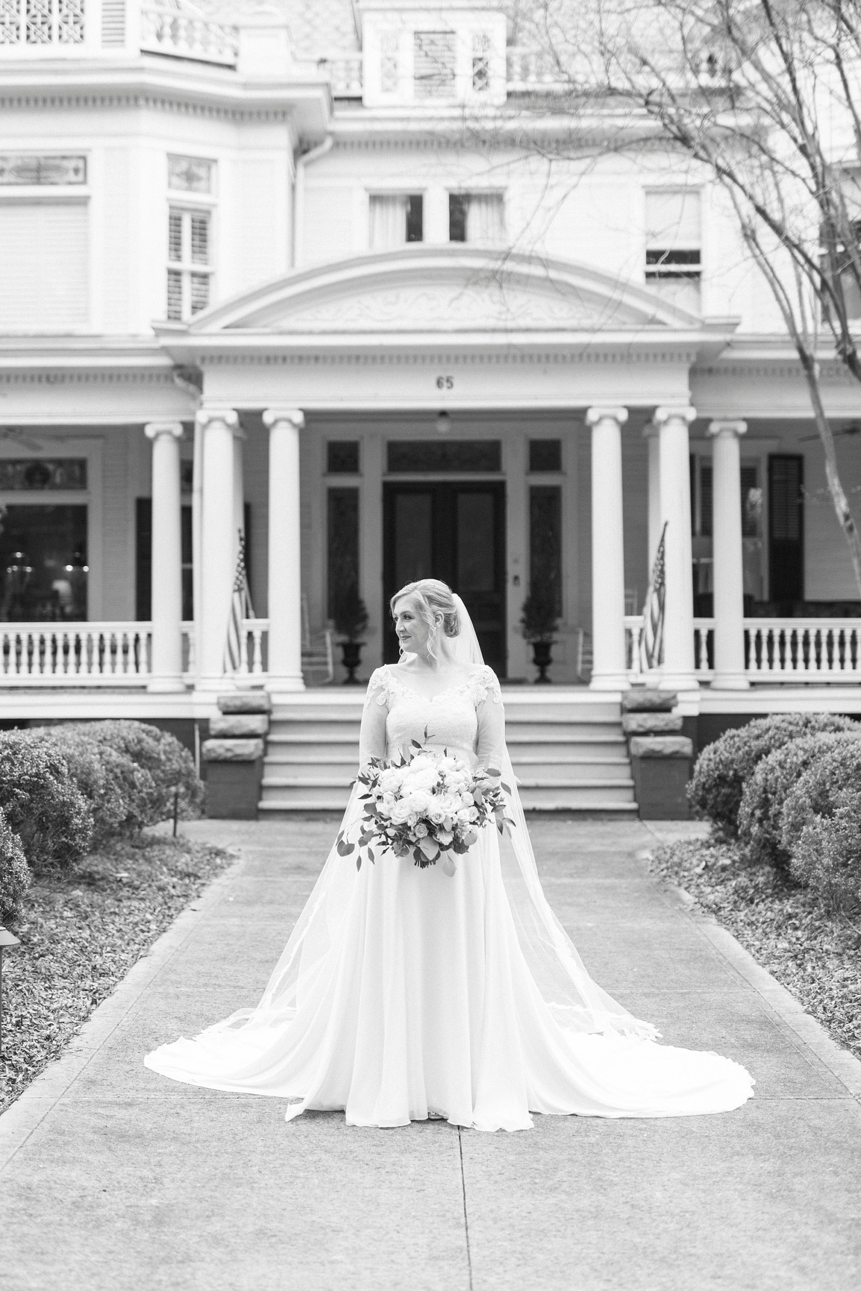 black and white portrait of bride outside historic home