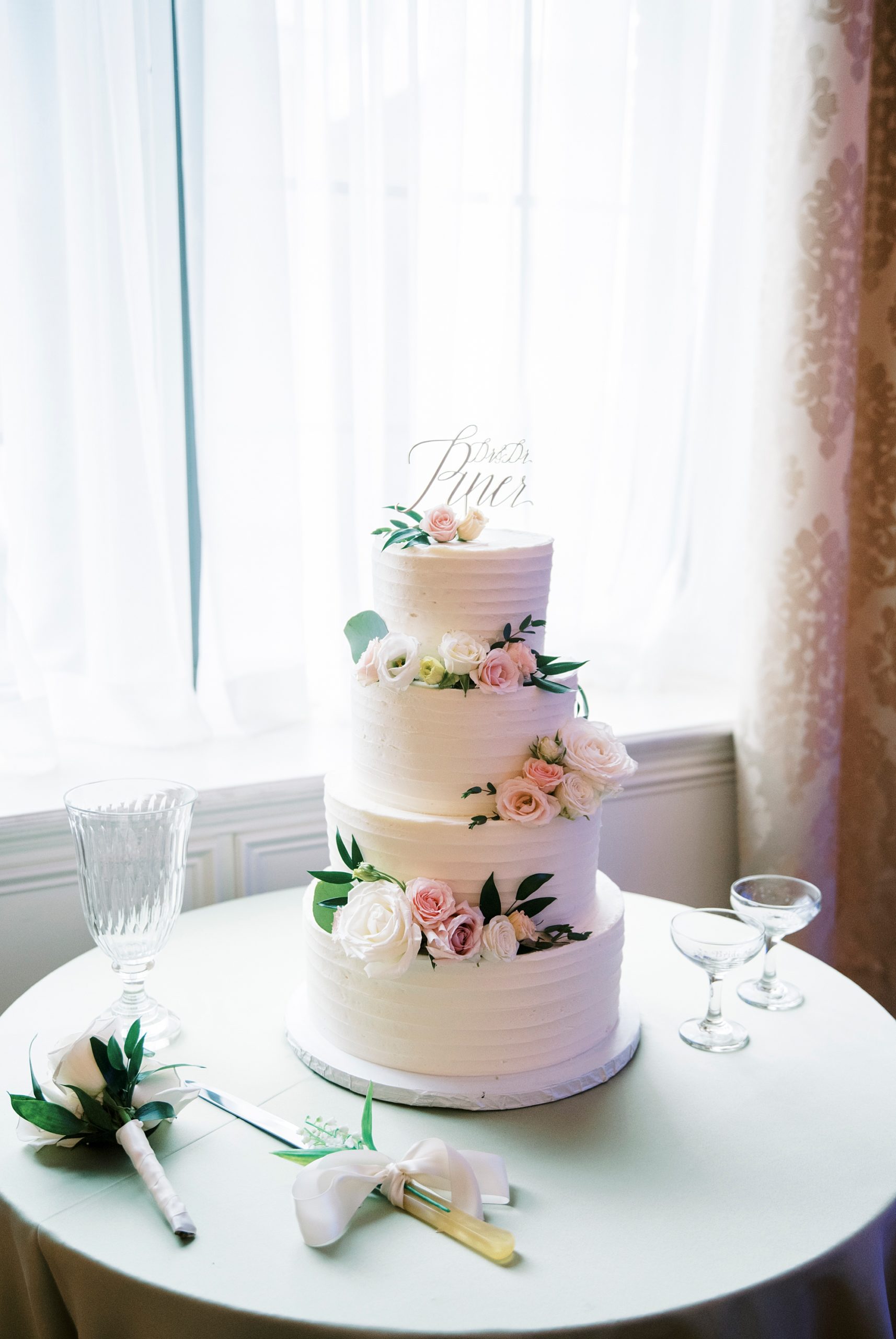 tiered wedding cake with pink flowers for Hotel Concord wedding reception 