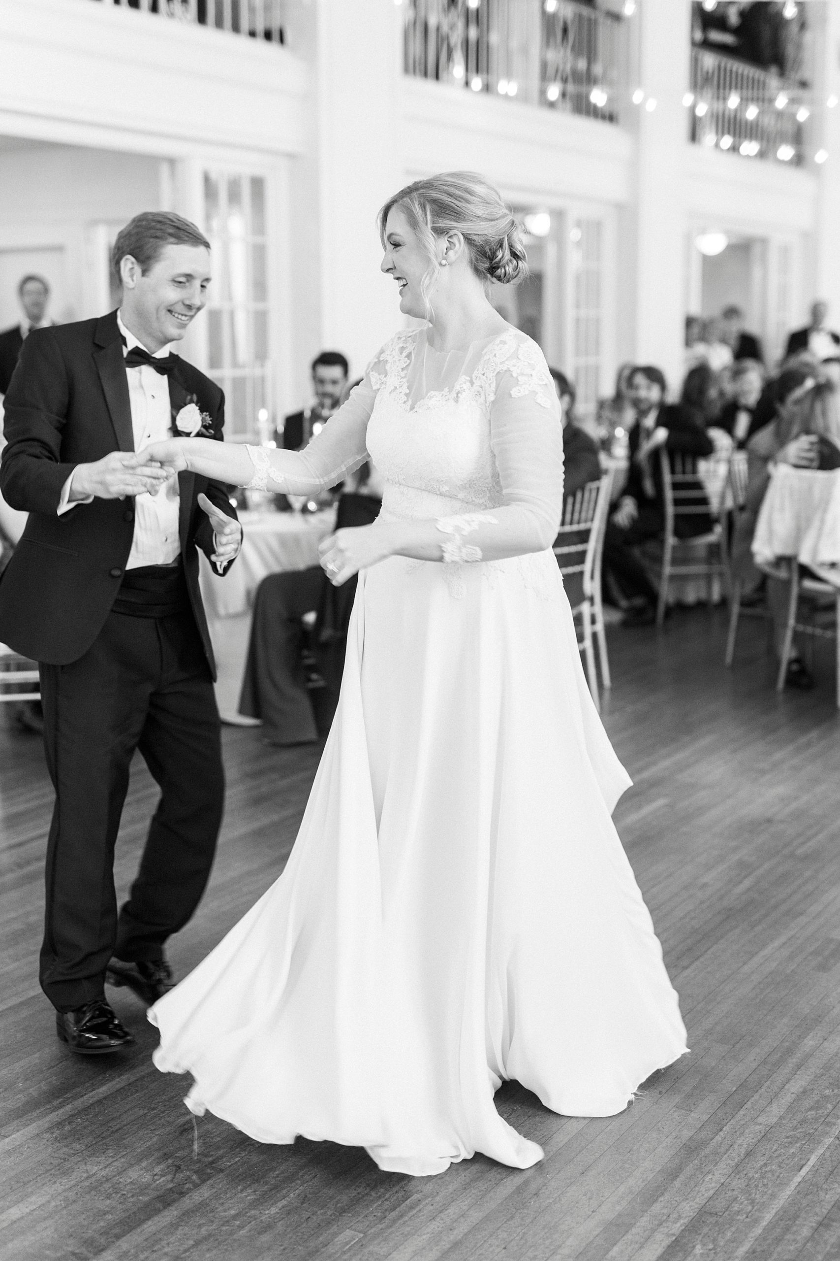 groom twirls bride during Concord NC wedding reception